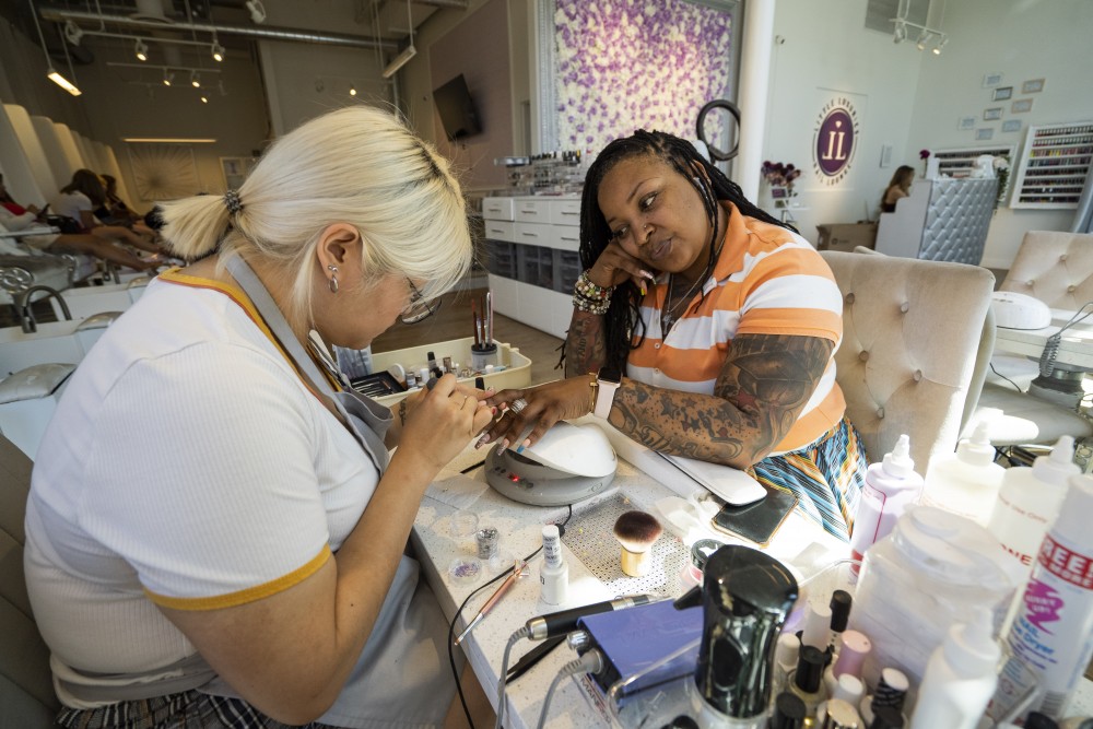 Nail artist Melody Vue paints Jelahn Prentiss nails at Little Luxuries Nail Lounge in Minneapolis on Tuesday, July 30. 
