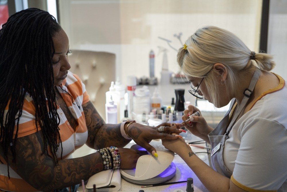 Nail artist Melody Vue paints Jelahn Prentiss nails  at Little Luxuries Nail Lounge in Minneapolis on Tuesday, July 30. 