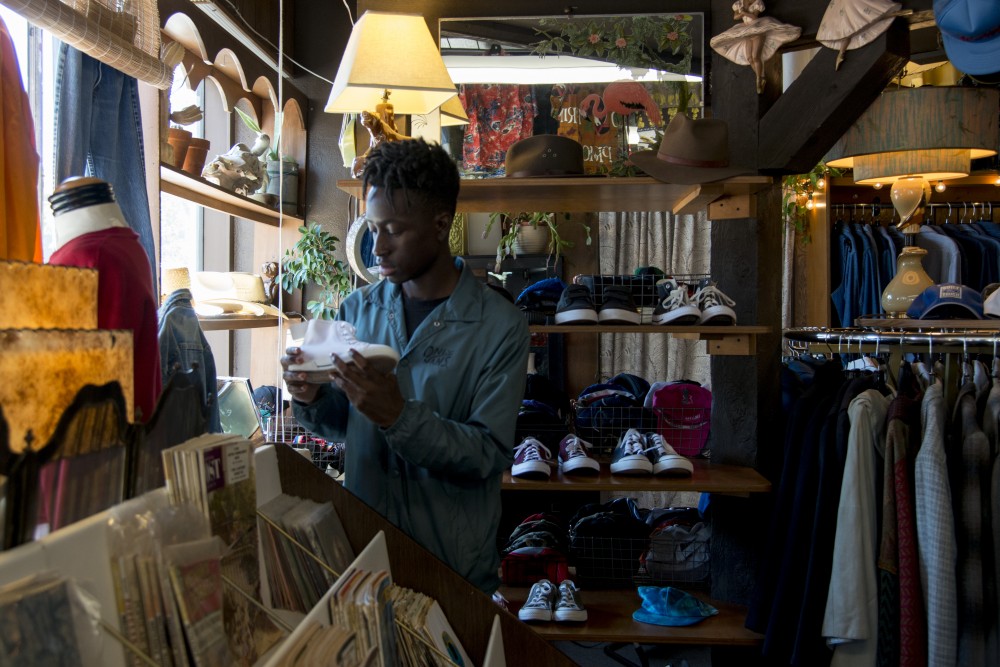 Justin Ofori-Atta looks at shoes inside Corner Store Vintage on Thursday, Aug. 29. 