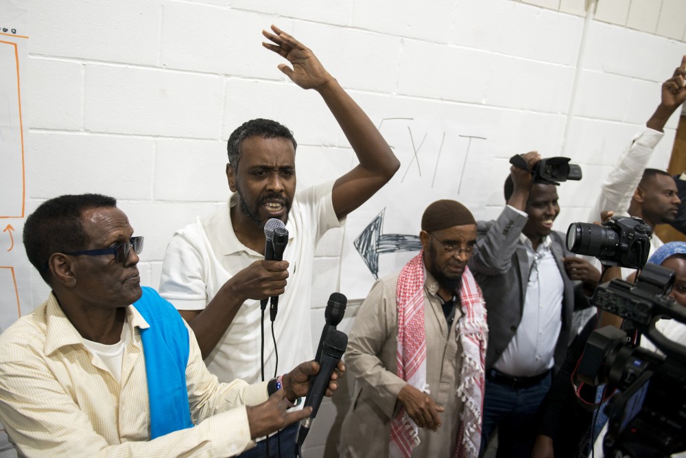 City Council Representative Abdi Warsame addresses the crowd at Pillsbury United Communities Brian Coyle Center on Friday, Aug. 30. The listening session was discontinued following demonstrations by protestors in the crowd.