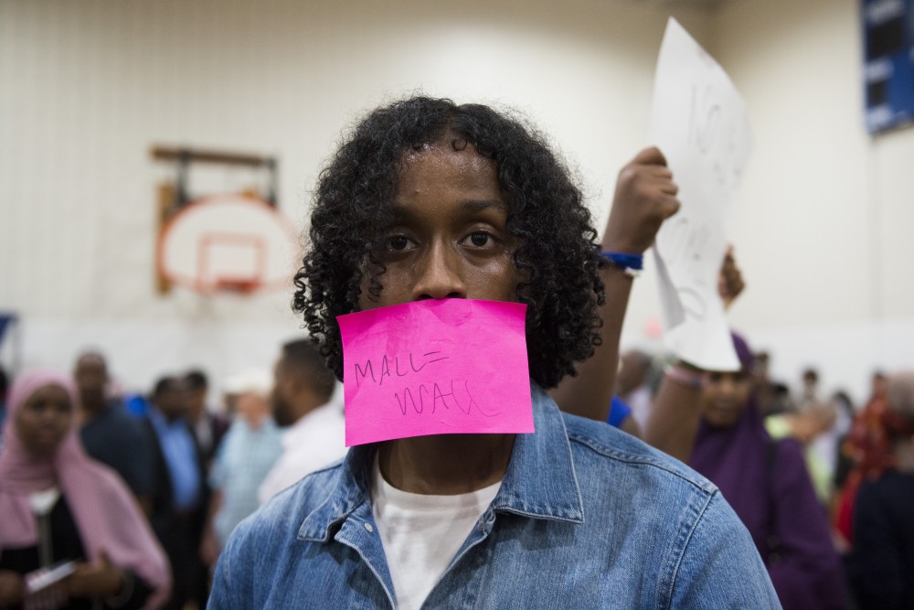 Cedar Riverside Resident Khaled Nassir demonstrates in the crowd at Pillsbury United Communities Brian Coyle Center on Friday, Aug. 30. The listening session was discontinued following demonstrations by protestors in the crowd.
