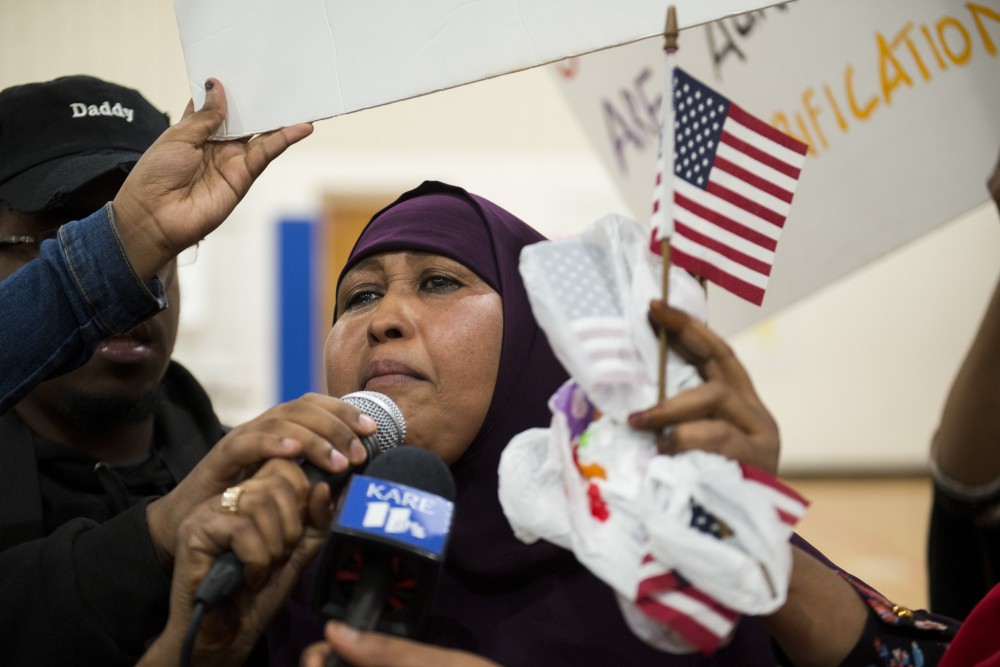 Cedar Riverside Resident Nasro Hassan addresses the crowd at Pillsbury United Communities Brian Coyle Center on Friday, Aug. 30. The listening session was discontinued following demonstrations by protestors in the crowd.