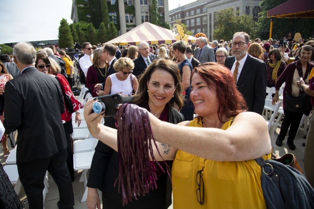 Attendees of the inauguration of Joan Gabel, the 17th President of the University of Minnesota, take selfies with her outside Northrop Memorial Auditorium on Friday, Sept 20, 2019.