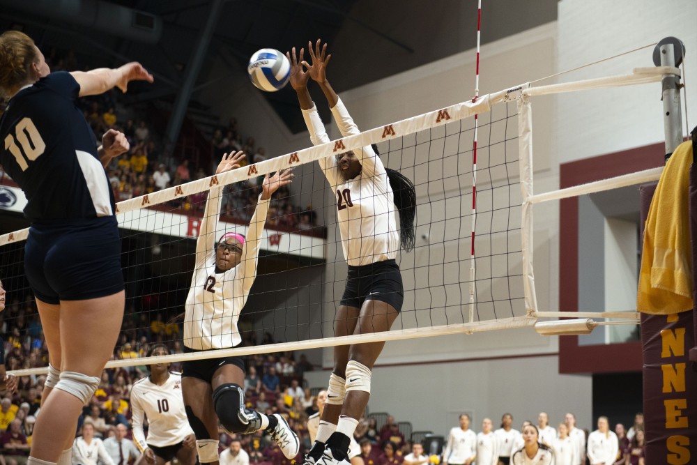 Redshirt Senior Taylor Morgan, left, and Sophomore Adanna Rollins, right, jump to block a spike at the Maturi Pavilion on Saturday, Sept. 21, 2019. The Gophers defeated Oral Roberts three matches to none.