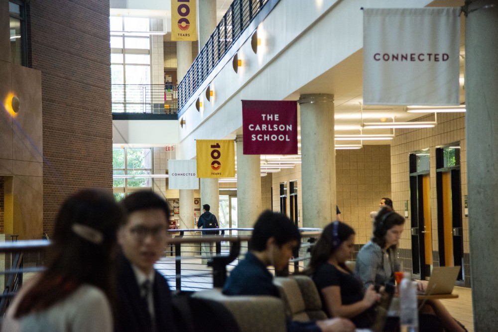 Students gather in a common area inside the Carlson School of Management on Thursday, Sept. 19, 2019. 