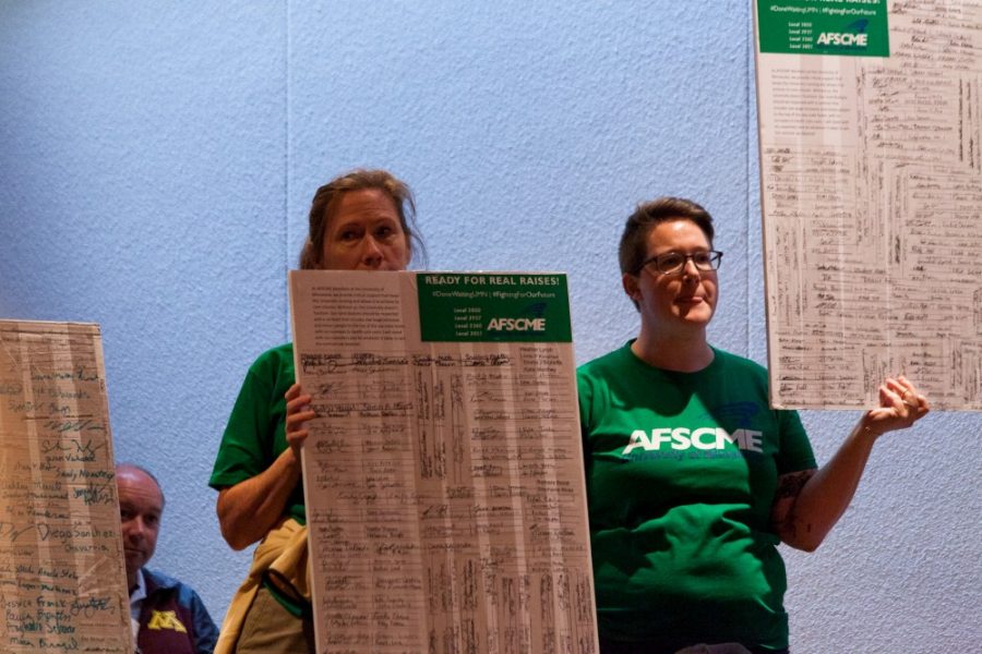 Members of AFSCME, an organization representing University of Minnesota clerical workers, interrupt the September Board of Regents meeting to call attention to stagnant wages at the McNamara Alumni Center on Friday, Sept. 13.  