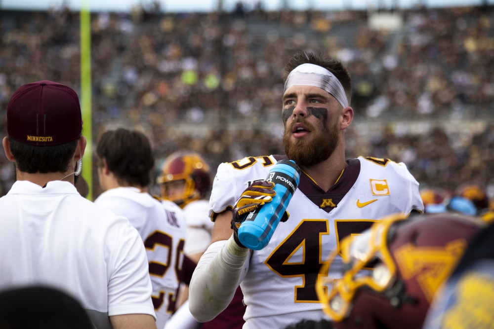 Linebacker Carter Coughlin takes a sip of water on the sidelines at Ross-Ade Stadium on Saturday, Sept. 28, 2019. The Gophers earned a 38-31 victory over Purdue.