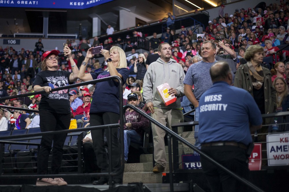 Rally attendees take photos and videos of the venue and its crowds at the Target Center on Thursday, Oct. 10. 