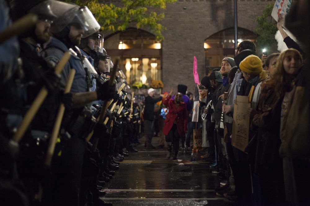 Protestors and police confront each other outside of the Target Center on Thursday, Oct. 10.