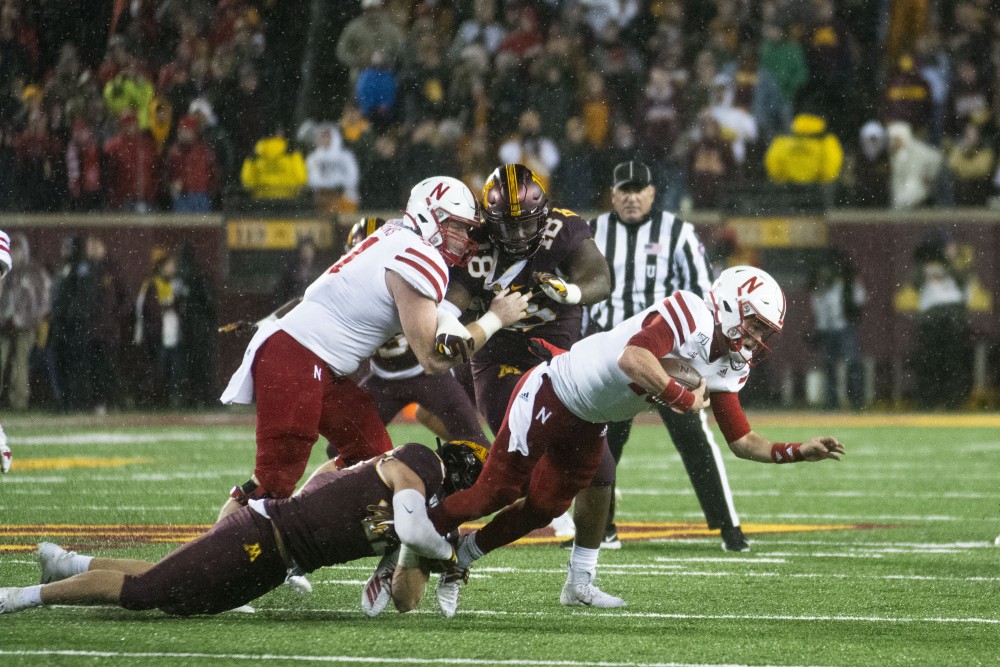 The Huskers ball carrier is tackled at TCF Bank Stadium on Saturday, Oct. 12.