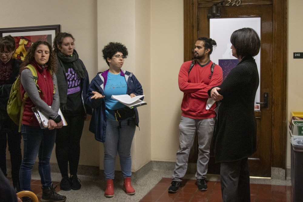 Thalya Reyes speaks to Senior Assistant to the President Kate Stuckert about affected individuals under the change in graduate student health plans on Thursday, Oct. 10 in Morrill Hall. 