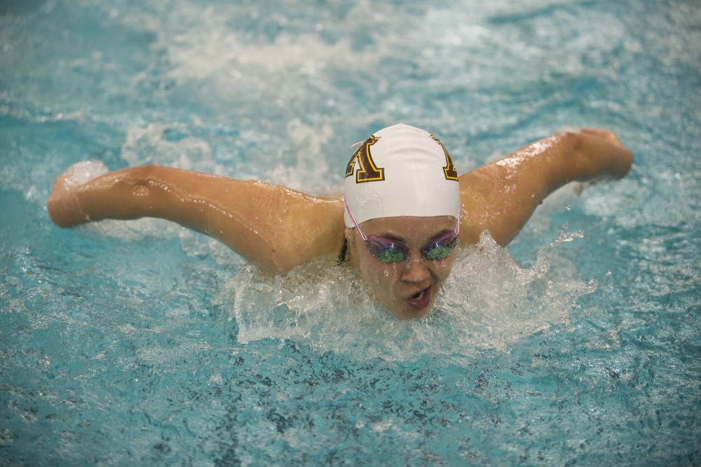 Freshman Grace Wollschlager competes against the University of Florida at the Jean K. Freeman Aquatic Center on Friday, Oct. 11.