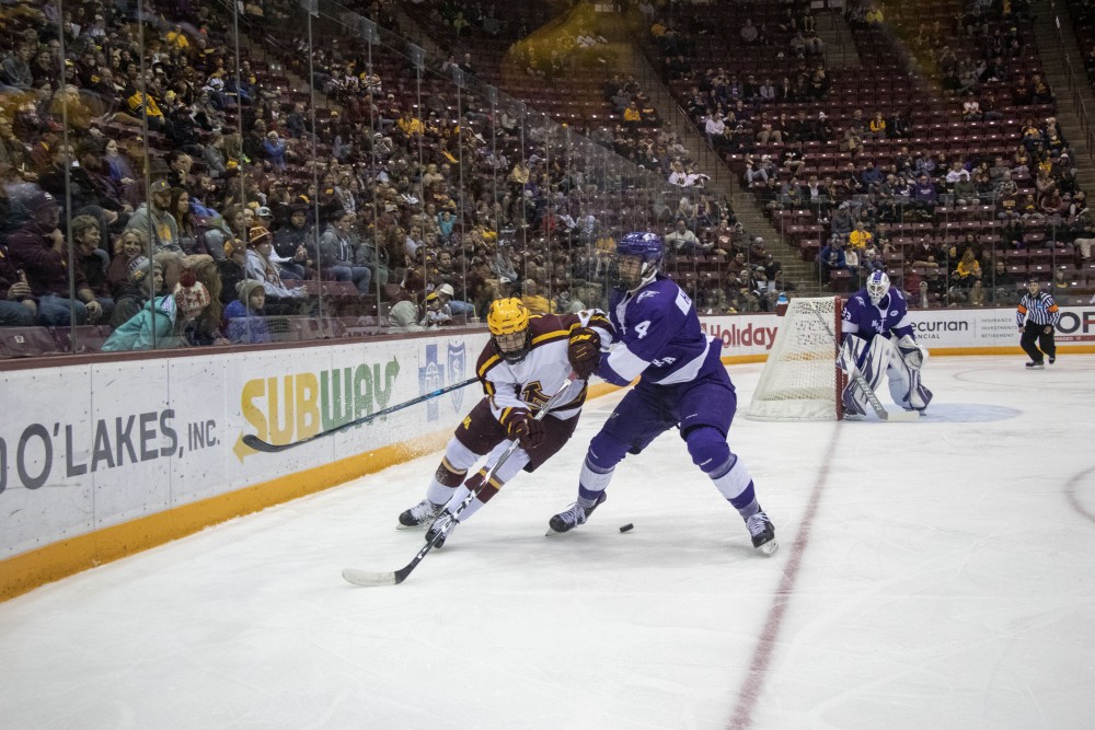 Forward Brannon McManus fights for the puck at 3M Arena at Mariucci on Friday, Oct. 18. The Gophers defeated Niagara 3-2. 