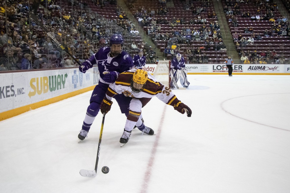 Forward Ben Meyers fights for the puck at 3M Arena at Mariucci on Friday, Oct. 18. The Gophers defeated Niagara 3-2. 