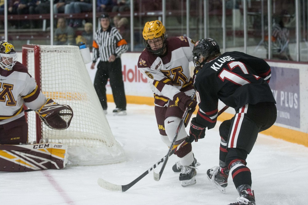Defender Gracie Ostertag fights for the puck at Ridder Arena on Saturday, Oct. 19. The Gophers defeated St. Cloud State 3-0. 