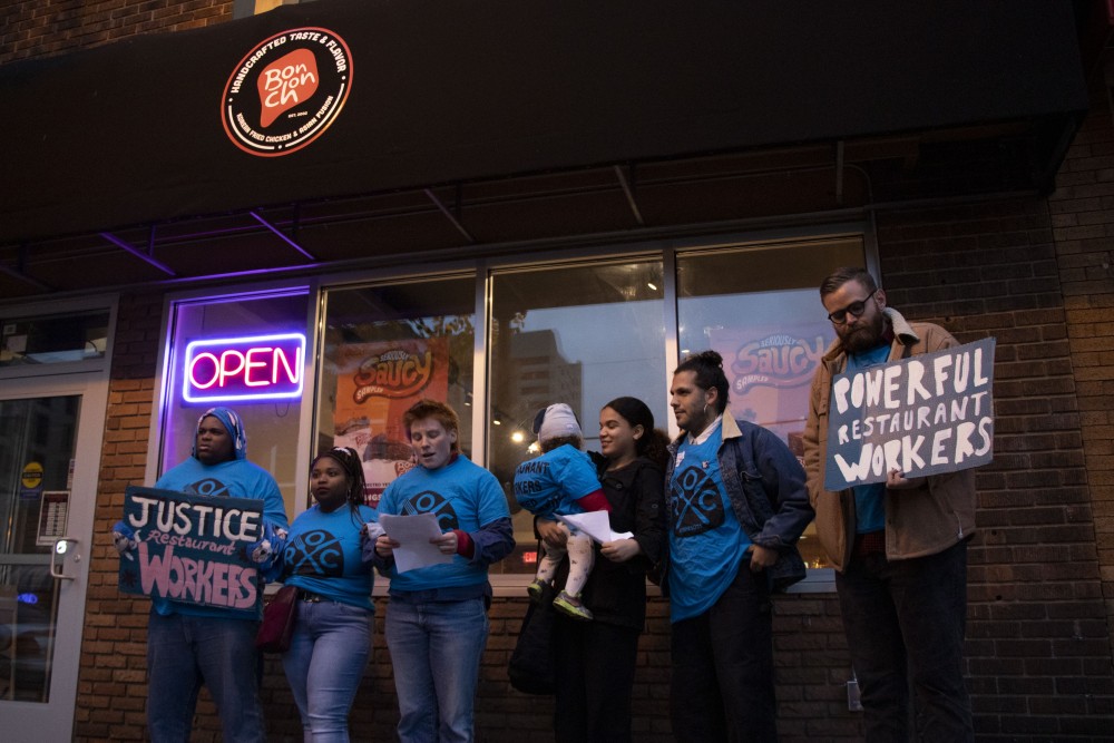 Erin Lynch of the Restaurant Opportunities Center of Minnesota announces a recent settlement for alleged stolen wages outside of Bonchon in Dinkytown on Tuesday, Oct. 22.