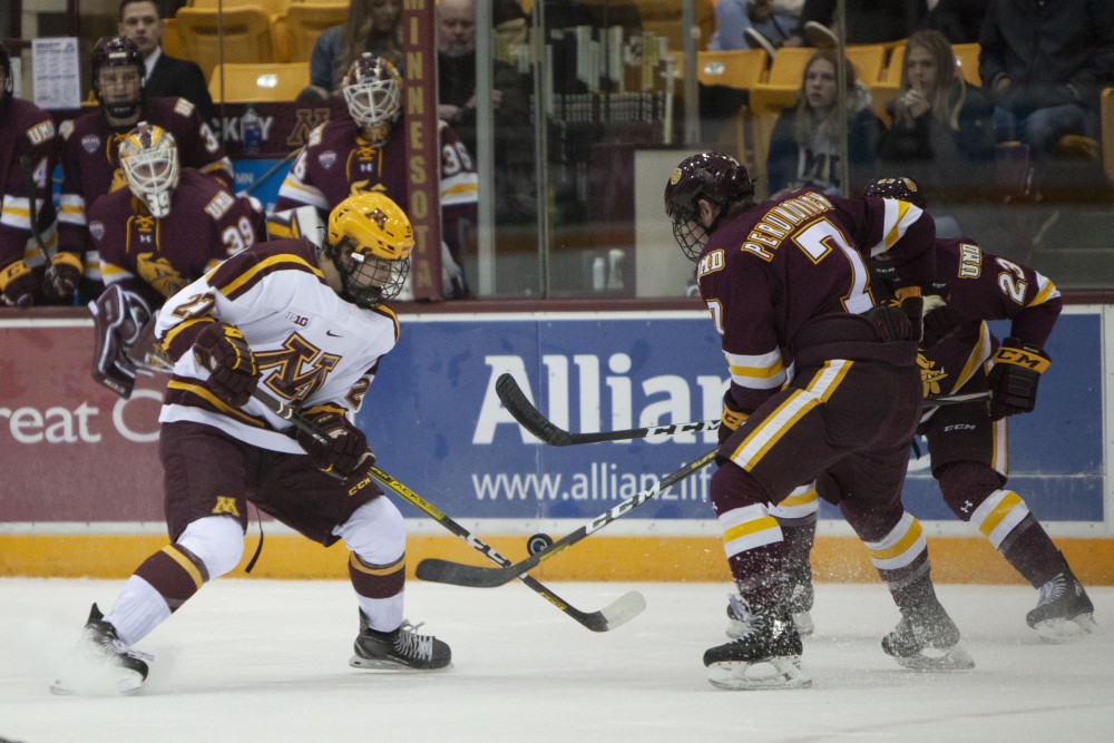 Forward Blake McLaughlin battles for the puck at the 3M Arena at Mariucci on Friday, Oct. 25. The Gophers went on to lose 2-5 to the University of Minnesota Duluth. 