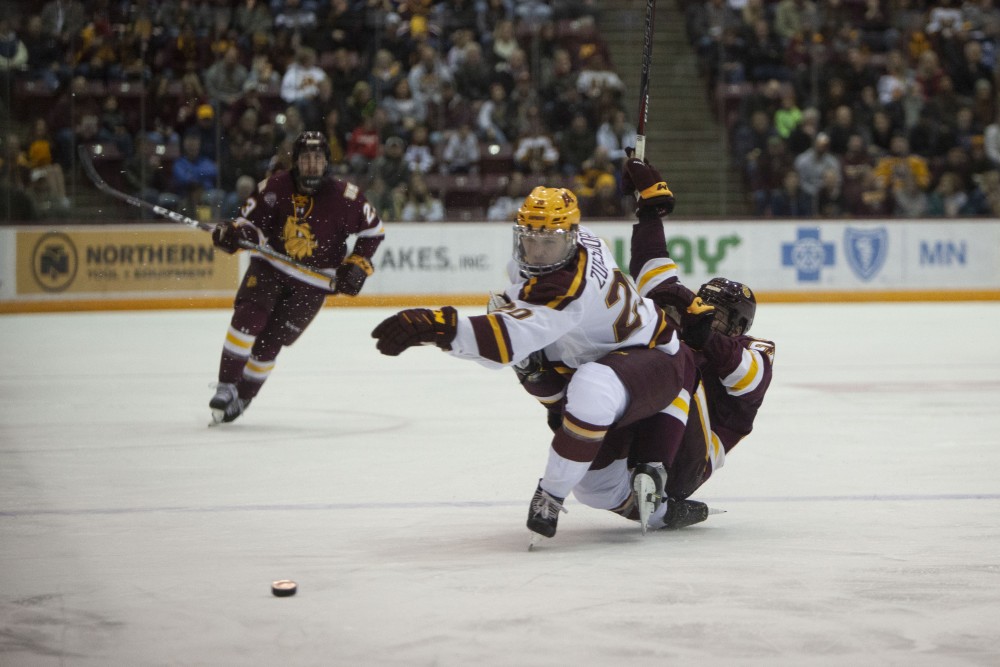 Defenseman Ryan Zuhlsdorf pushes aside a defender at the 3M Arena at Mariucci on Friday, Oct. 25. The Gophers went on to lose 2-5 to the University of Minnesota Duluth. 
