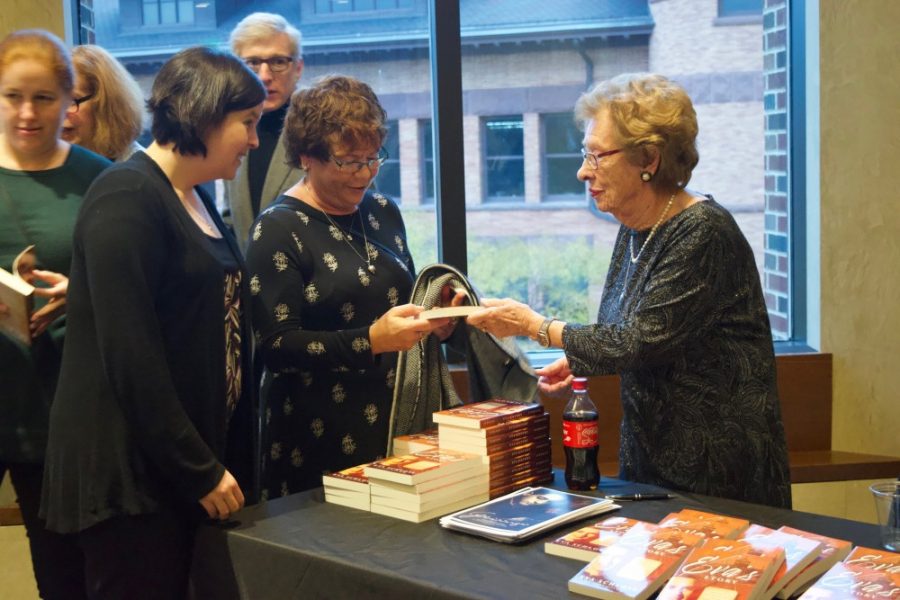 Holocaust survivor and stepsister of Anne Frank, Eva Schloss, signs copies of her memoir during an event at Northrop Auditorium on Sunday, Oct. 27.