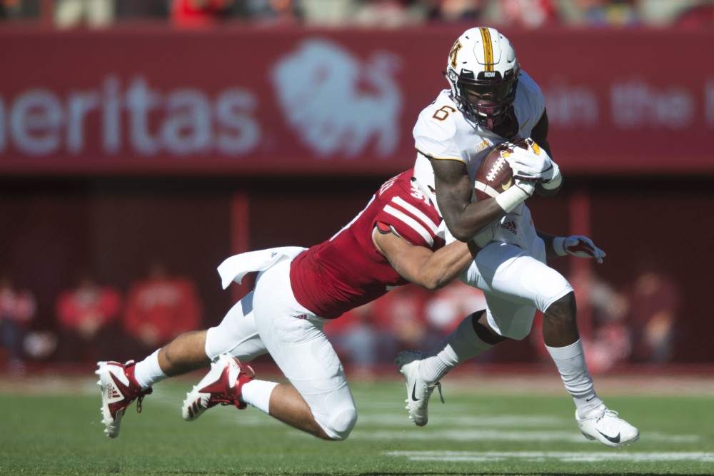 Wide receiver Tyler Johnson attempts to avoid being tackled on Saturday, Oct. 20 at Memorial Stadium. Nebraska defeated the Gophers with a final score of 53-28. 