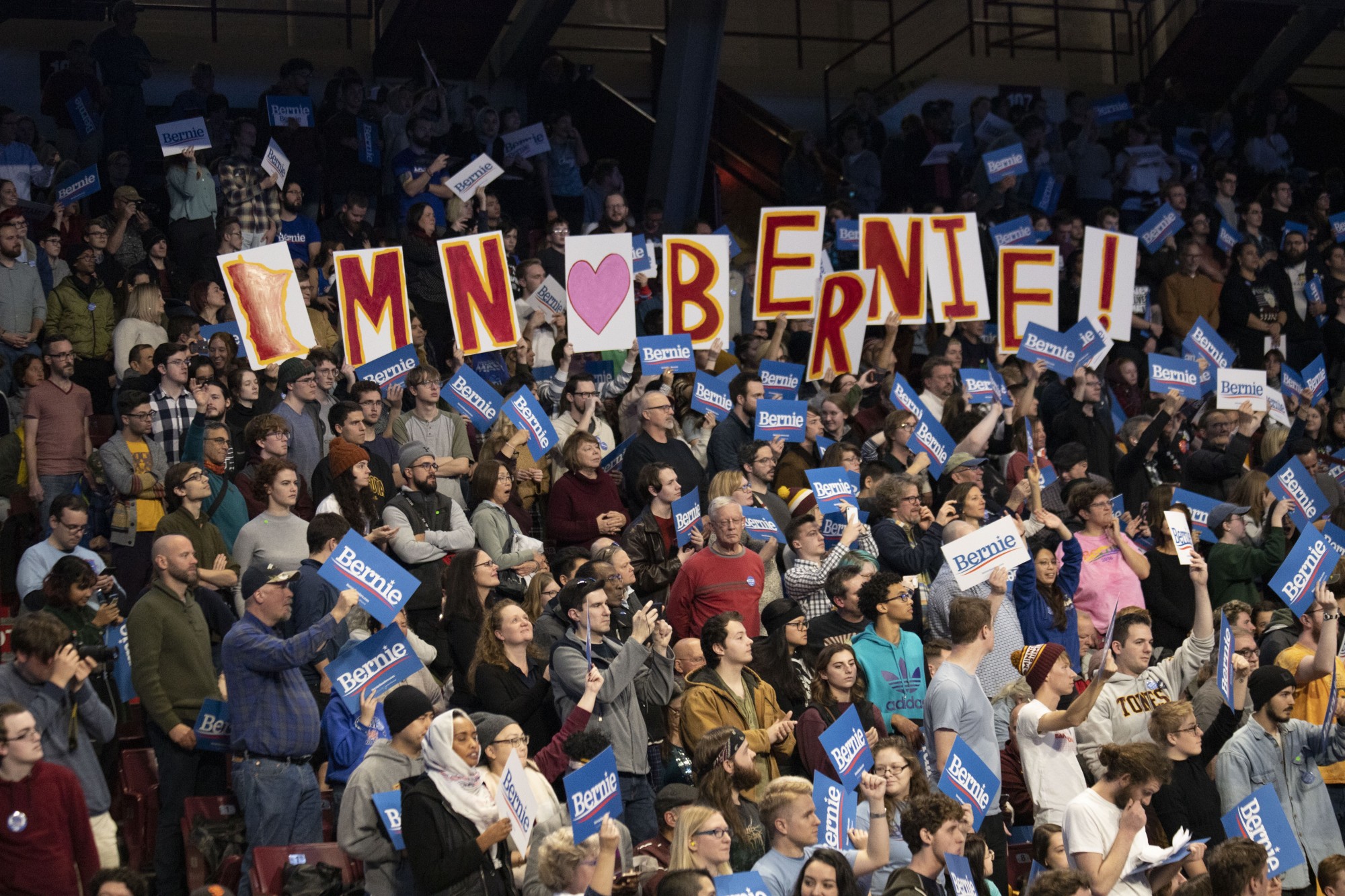 Rally attendees hold up signs supporting U.S. Senator Bernie Sanders at Williams Arena on Sunday, Nov. 3.