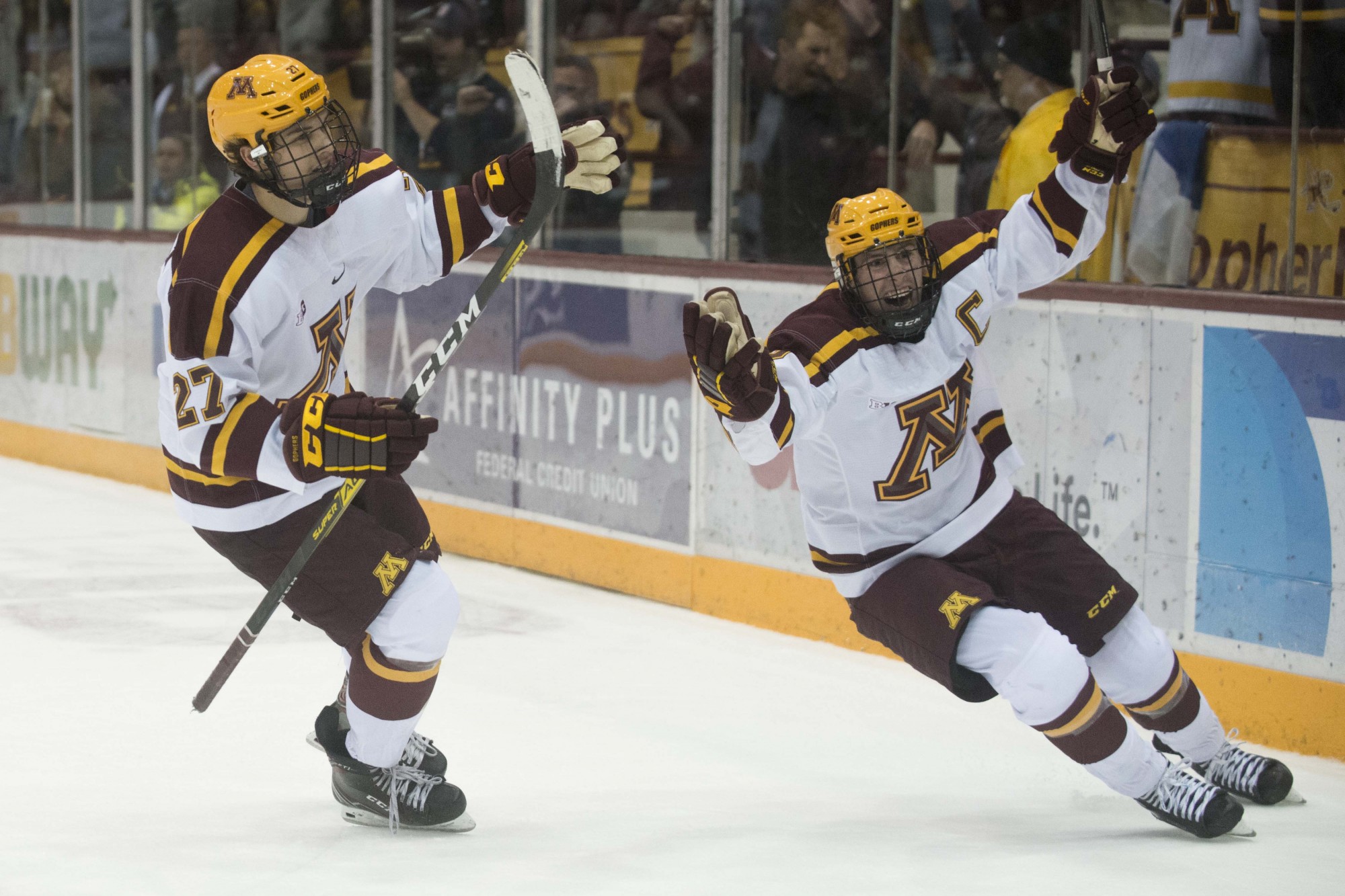Forwards Blake McLaughlin and Sammy Walker smile after the winning goal was scored against the Notre Dame Fighting Irish at 3M Arena at Mariucci on Friday, Nov. 1. The Gophers won 3-2 in double overtime. 