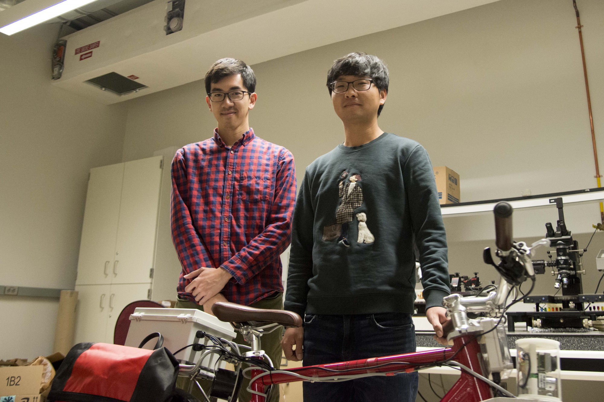 Zhenming Xiem, left. and Woongsun Jeon, right, pose for a portrait in the Mechanical Engineering building on Monday, Nov. 4. Xiem and Jeon have been working on a prototype bike system since 2015 to help improve cyclist safety. 