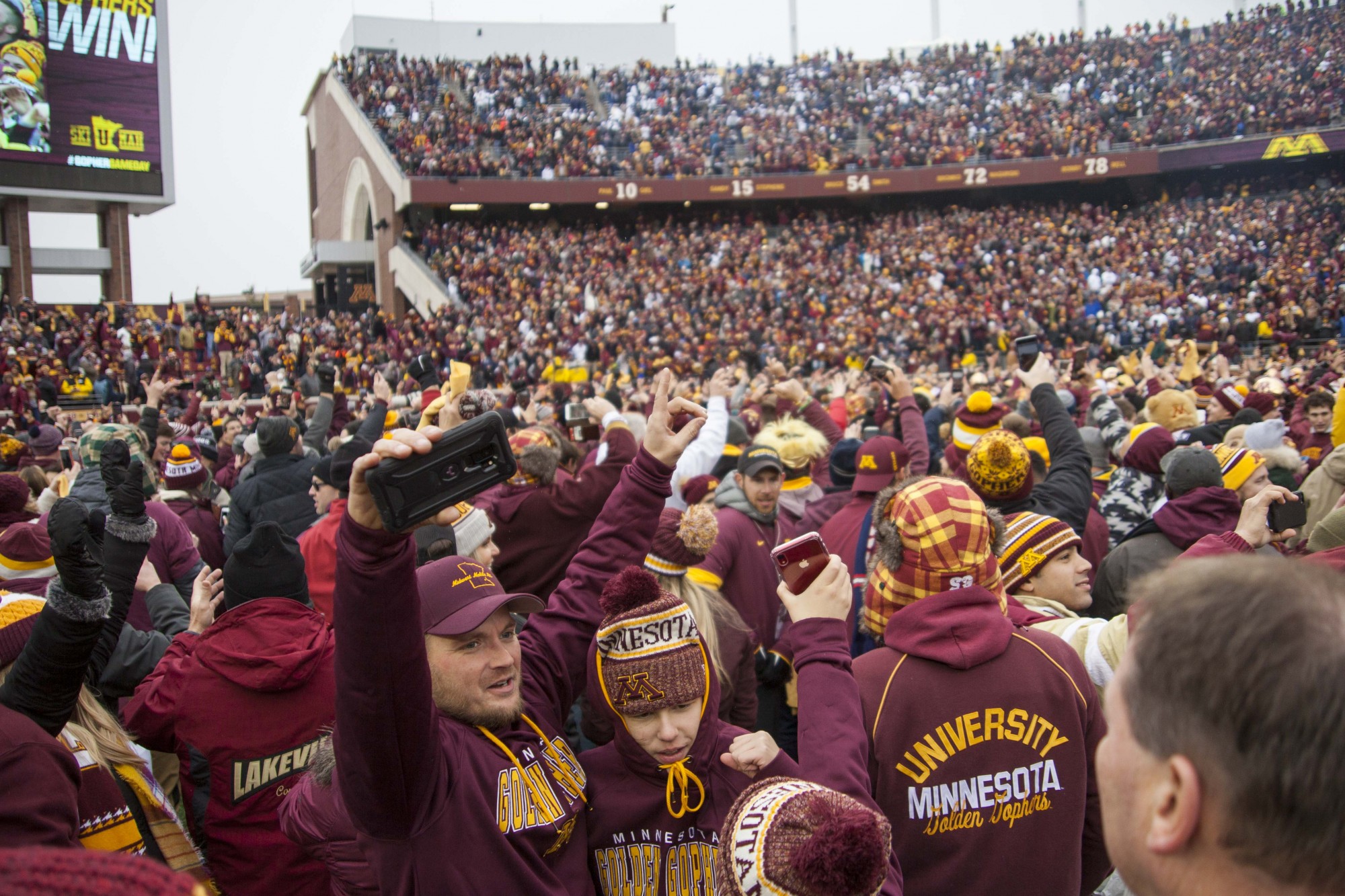 Fans rush the field at TCF Bank Stadium on Saturday, Nov. 9 following the Gophers 31-26 win over Penn State. The win brings their record to 9-0. A first since 1940. 