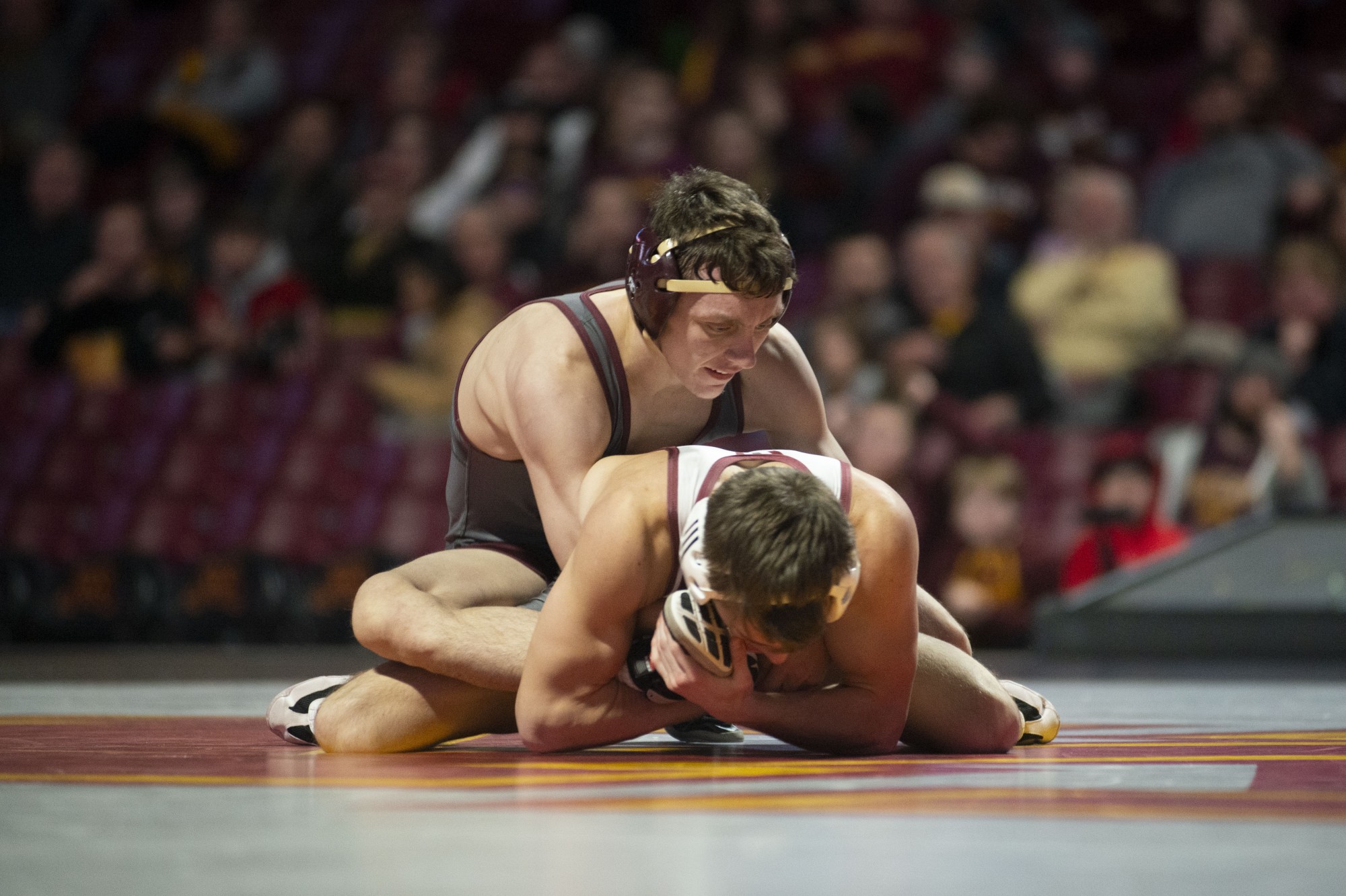 Redshirt Sophomore Brent Jones holds an opposing Rider wrestler at Williams Arena on Friday, Nov. 15. The Gophers went on to fall to Rider with a final score of 21-17. 