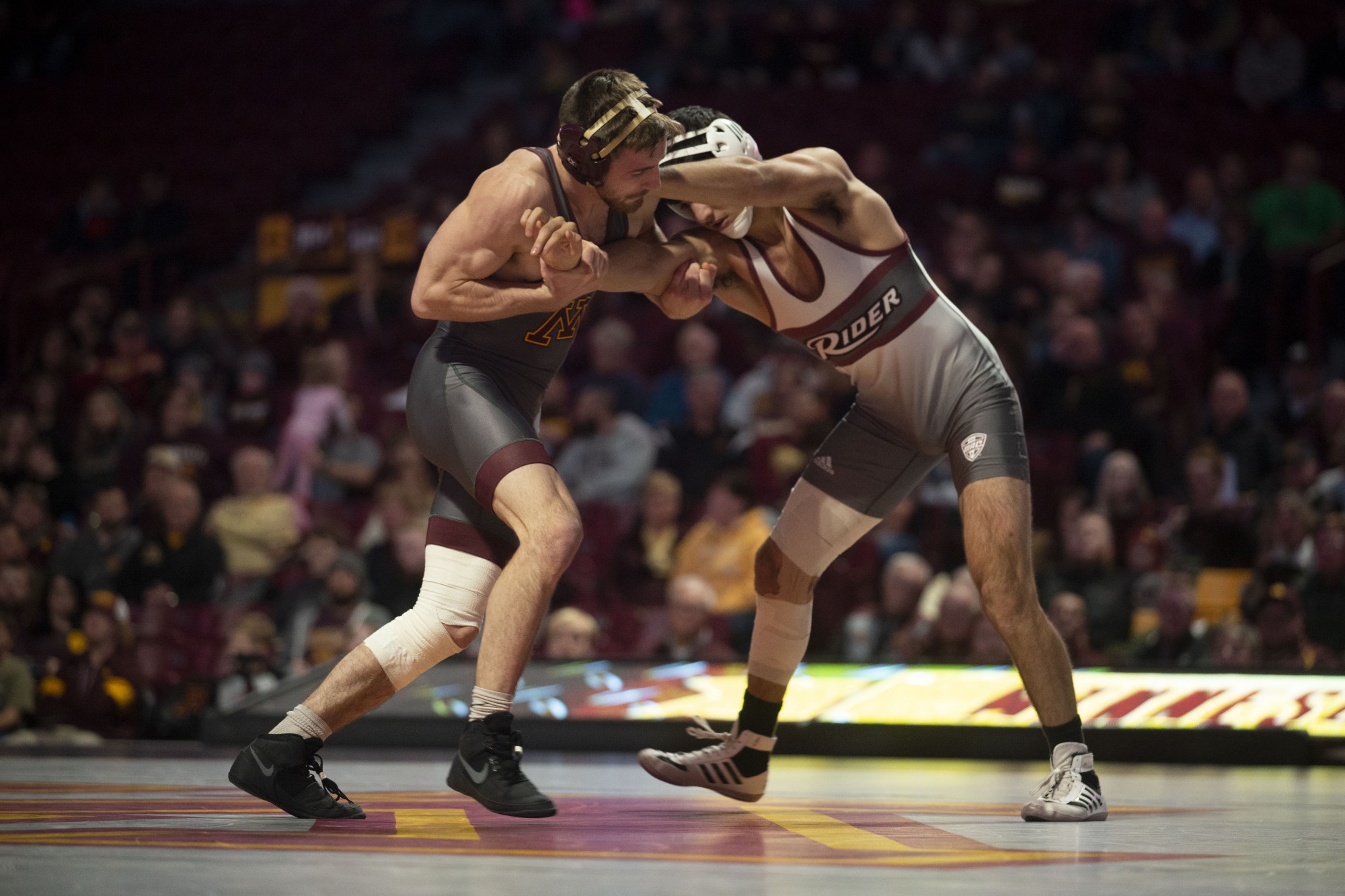 Redshirt Senior Carson Brolsma holds an opposing Rider wrestler at Williams Arena on Friday, Nov. 15. The Gophers went on to fall to Rider with a final score of 21-17. 