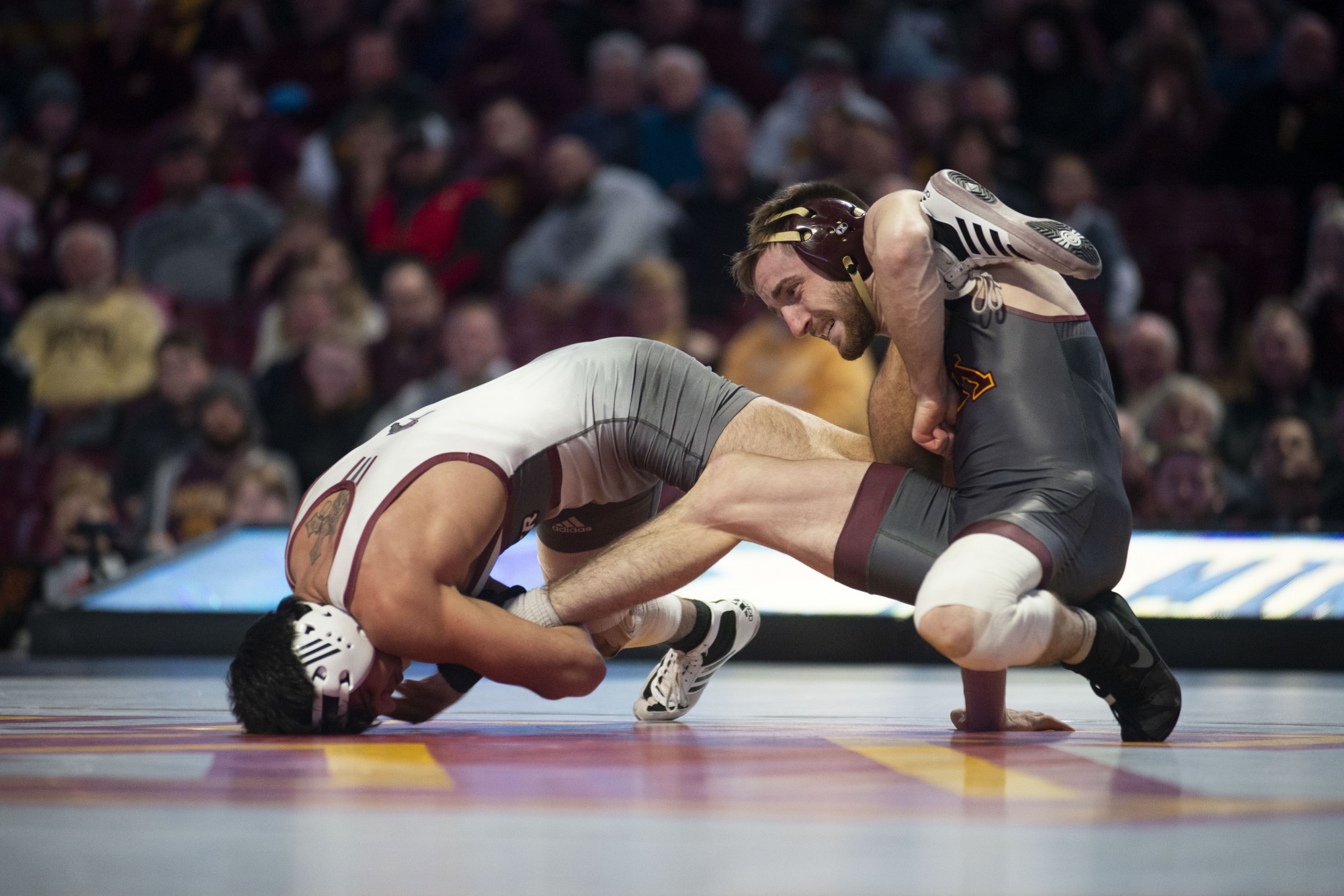 Redshirt Senior Carson Brolsma holds an opposing Rider wrestler at Williams Arena on Friday, Nov. 15. The Gophers went on to fall to Rider with a final score of 21-17. 