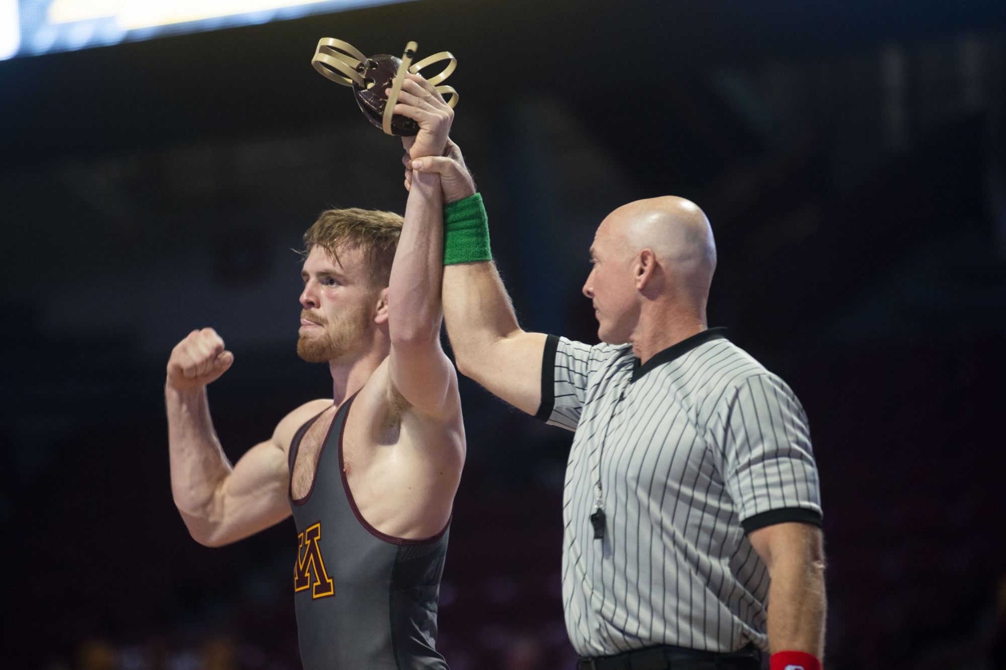 Redshirt Sophomore Bailee OReilly raises his hand in victory after defeating an opposing Rider wrestler at Williams Arena on Friday, Nov. 15. The Gophers went on to fall to Rider with a final score of 21-17. 