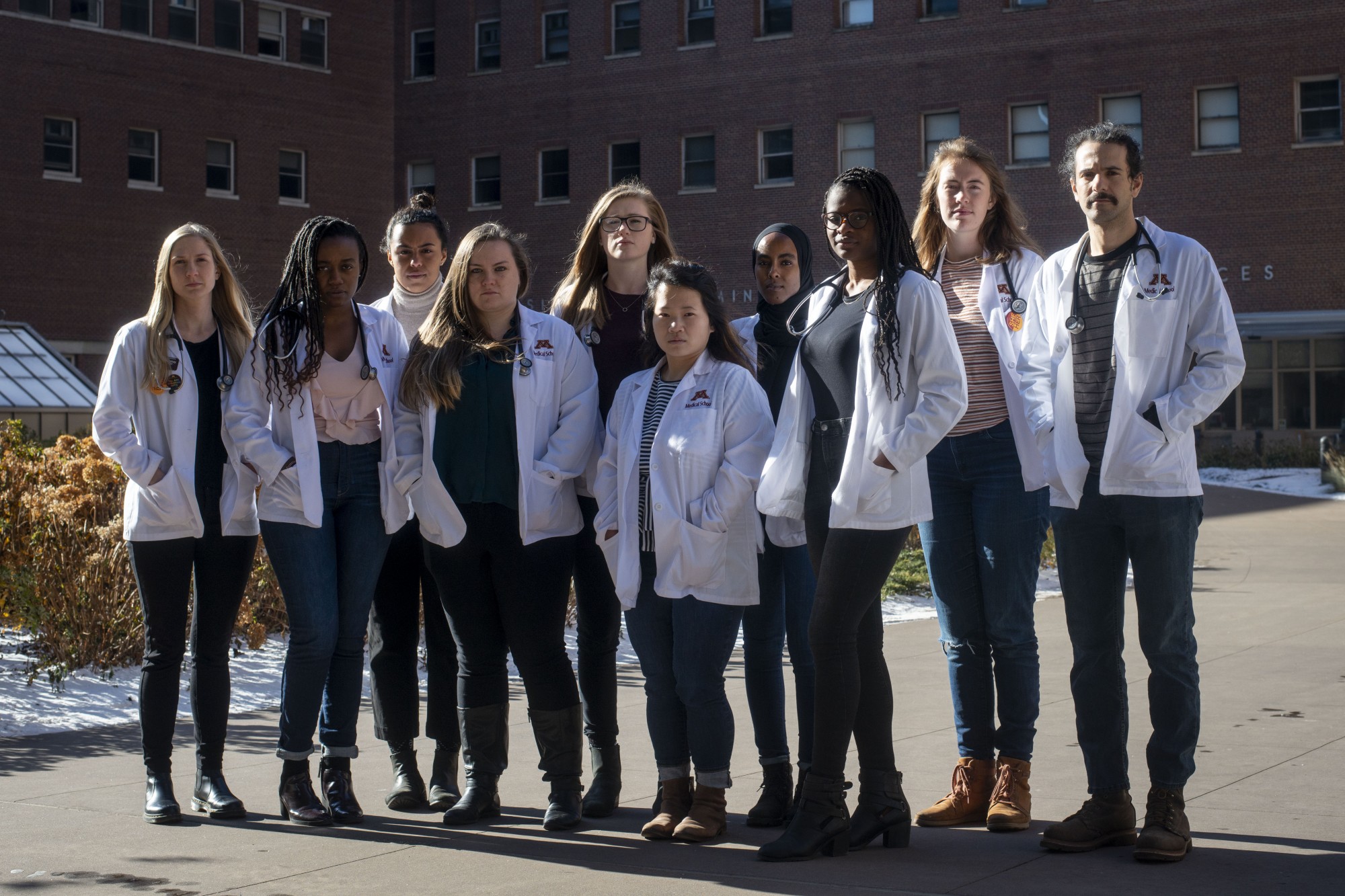 White Coats for Black Lives members pose for a portrait outside of Malcolm Moos Health Sciences Tower on Thursday, Nov. 14. WCBL is a medical student group working to overcome racial bias in medicine. 
