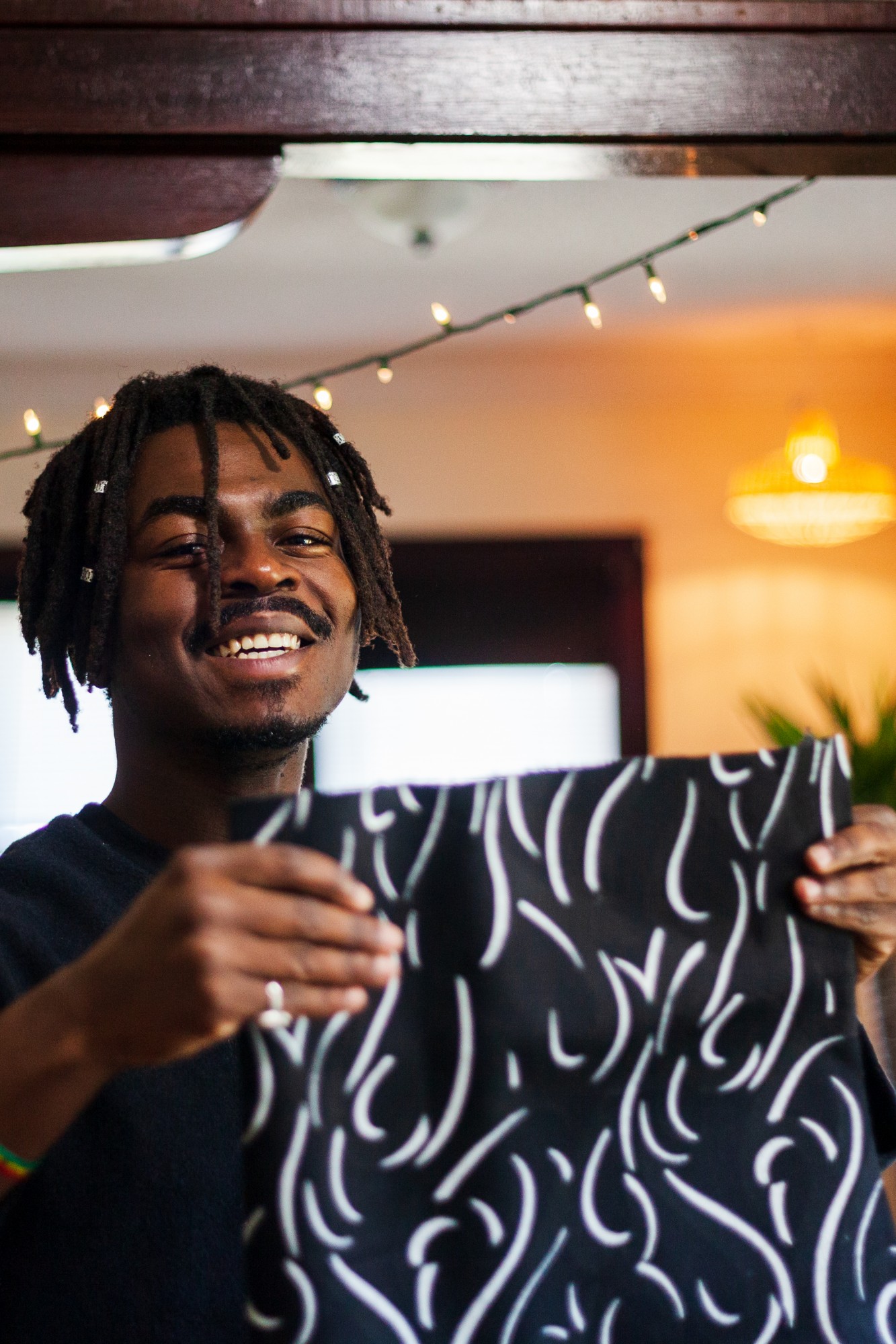 Denimani gathers fabric to begin working on a custom piece in his apartment studio in northwest Minneapolis on Friday, Oct. 25. Denimani sees clothing as an important means of expressing personality which is apparent in the uniqueness of his high quality, made-to-order apparel. 
