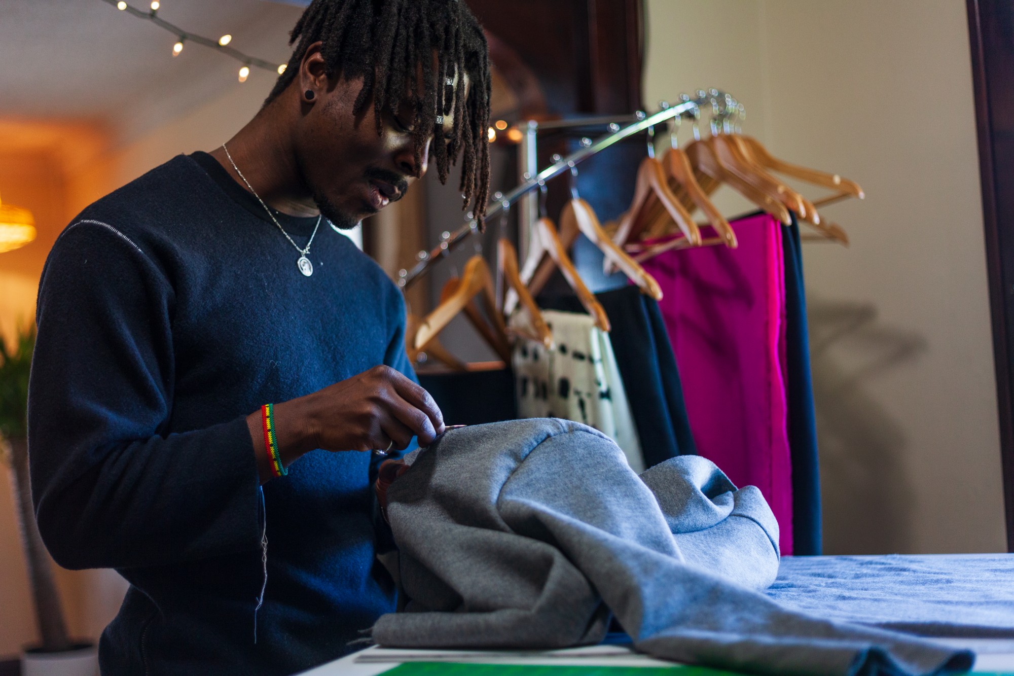 Denimani, whose work is promoted with the help of social media and a growing Minneapolis fashion network, examines a nearly-completed coat. 