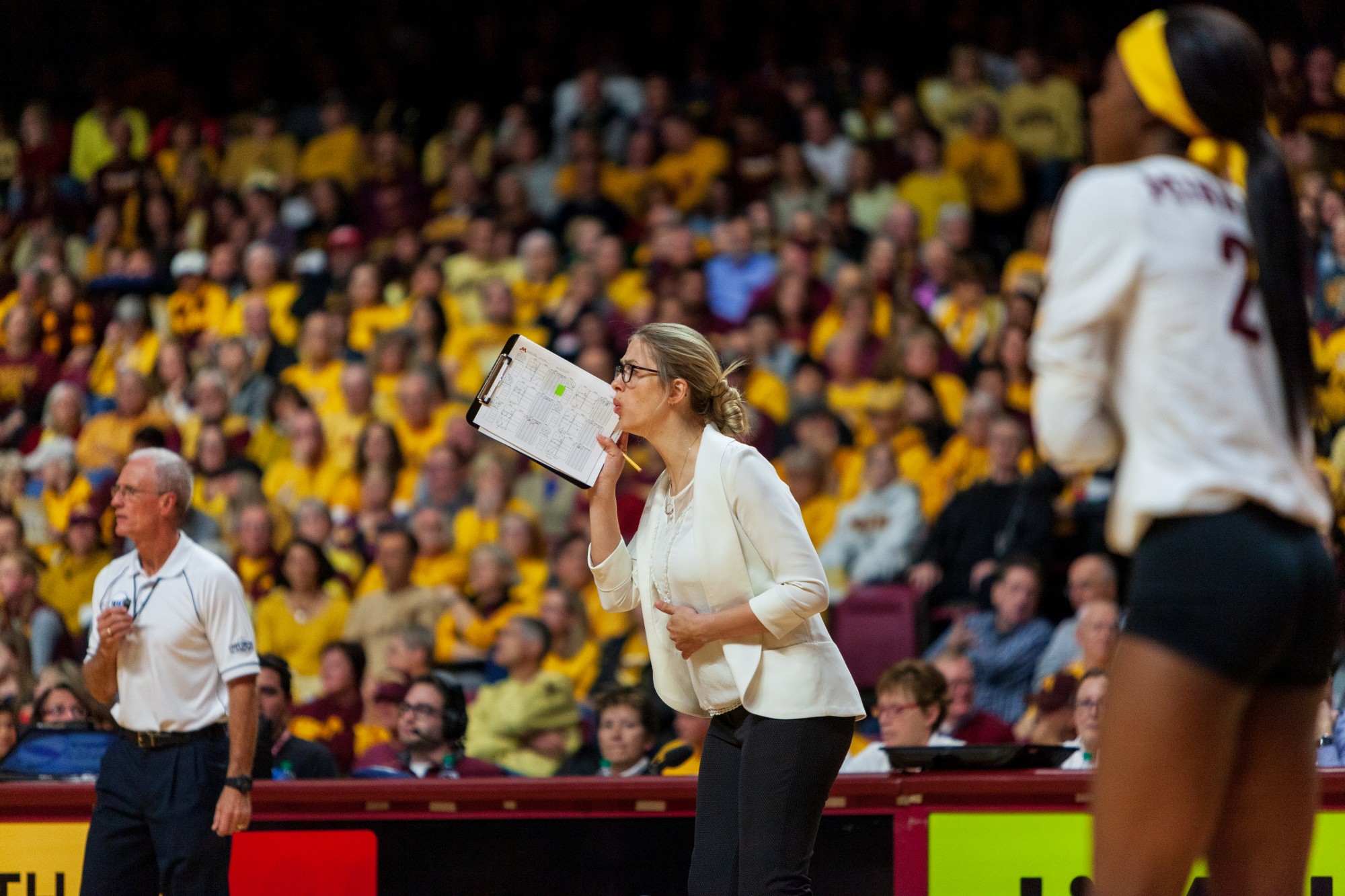 Associate Head Coach Laura Kasey yells from the sidelines at the Maturi Pavilion on Thursday, Nov. 14. The Gophers ended the night with a 3-1 loss against the Badgers. 