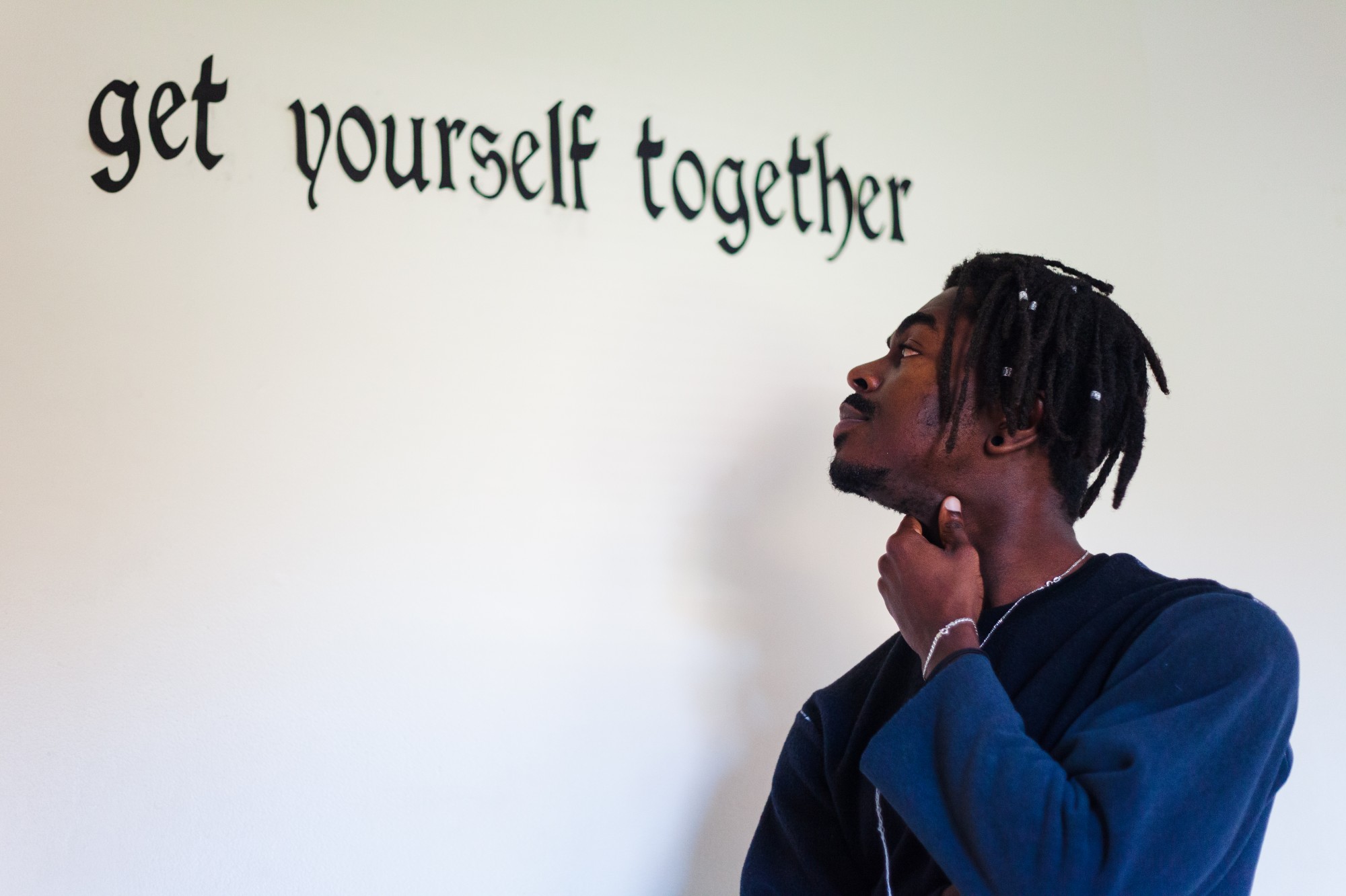 Get Yourself Together, the theme of his recently released apparel line, adorns a wall in Denimanis apartment studio. 