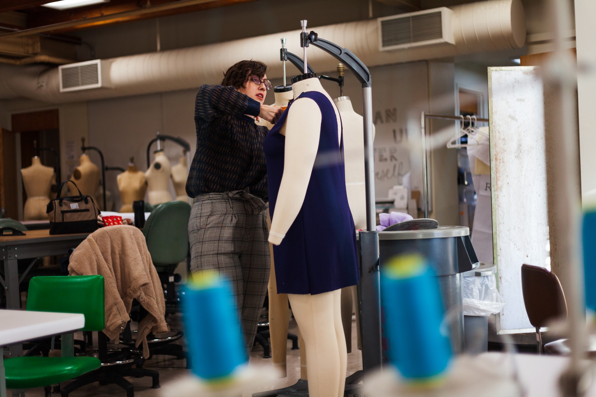 Maxine Britt pins a piece from her upcoming line on a size eighteen mannequin. The University of Minnesota employs a myriad of mannequin body shapes which are an indispensable tool for increasing accessibility to apparel that supports positive personal identity. 