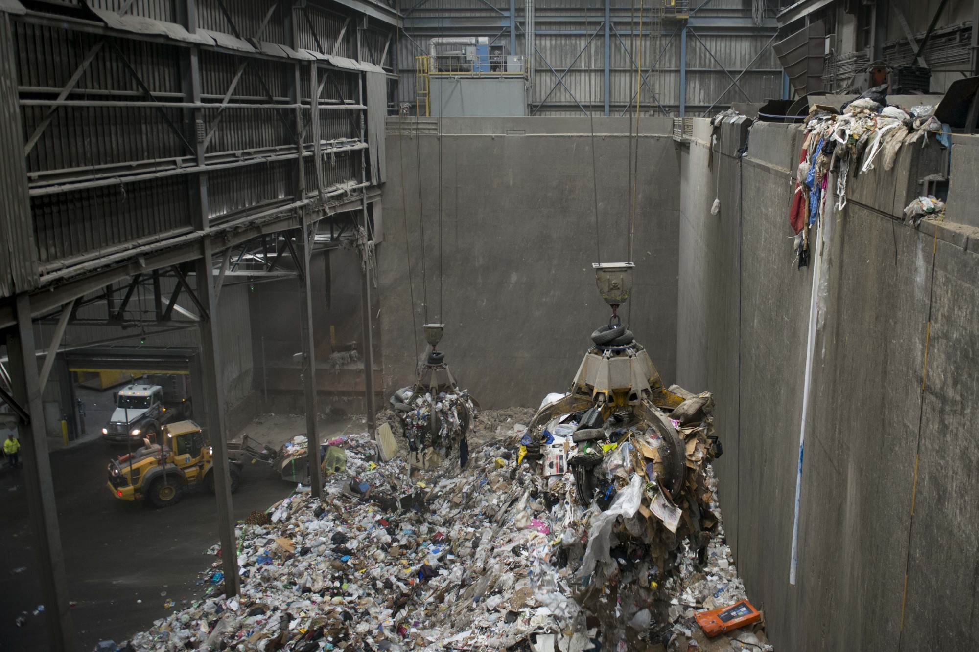A crane picks up trash to be distributed in bins and transported to the incinerator at the Hennepin Energy Recovery Center in Minneapolis on Wednesday, Dec. 4.
