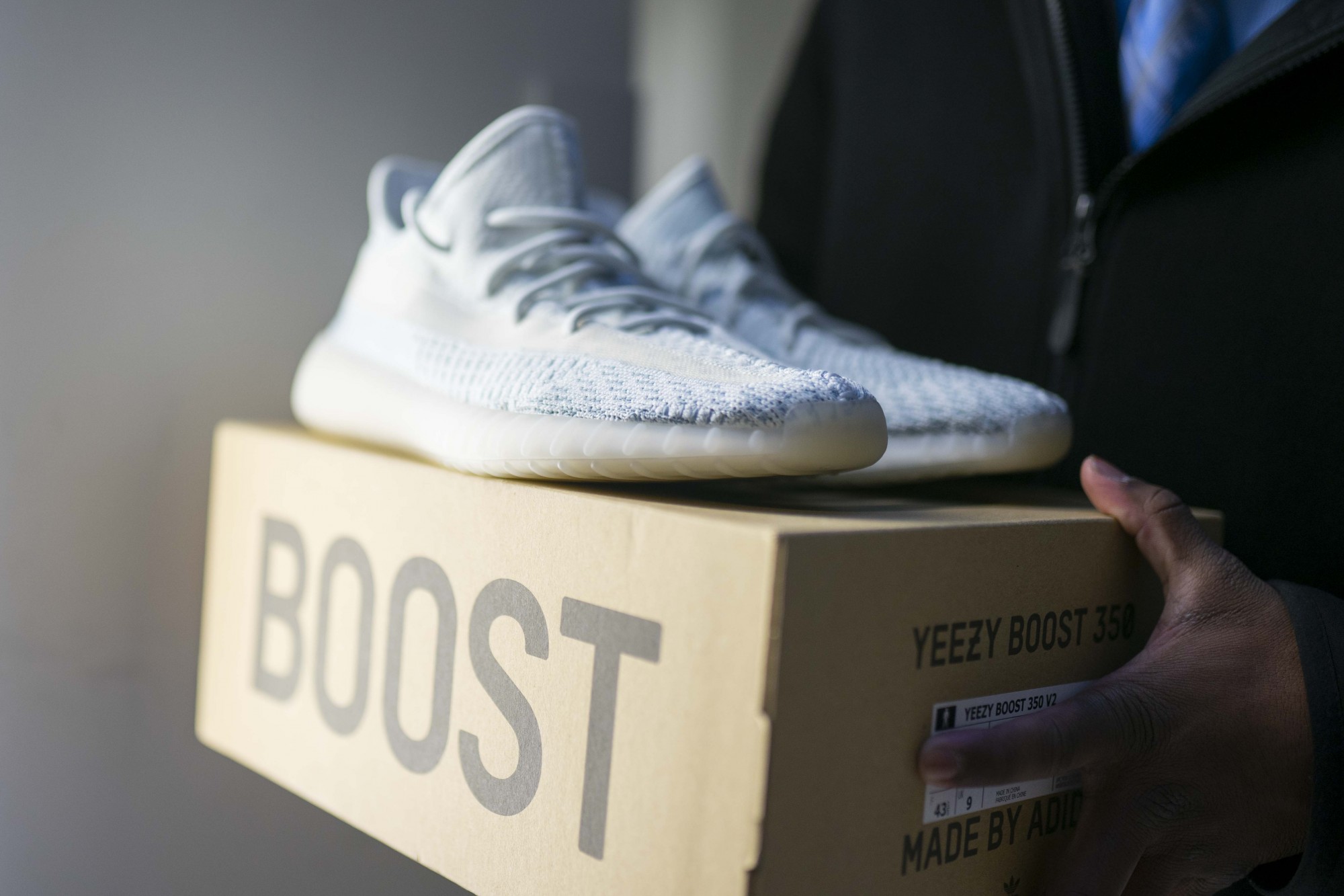 Keyshawn Jokhoo, a second-year finance student, poses with Yeezys that he plans to resell to customers on Wednesday, Dec. 4. 