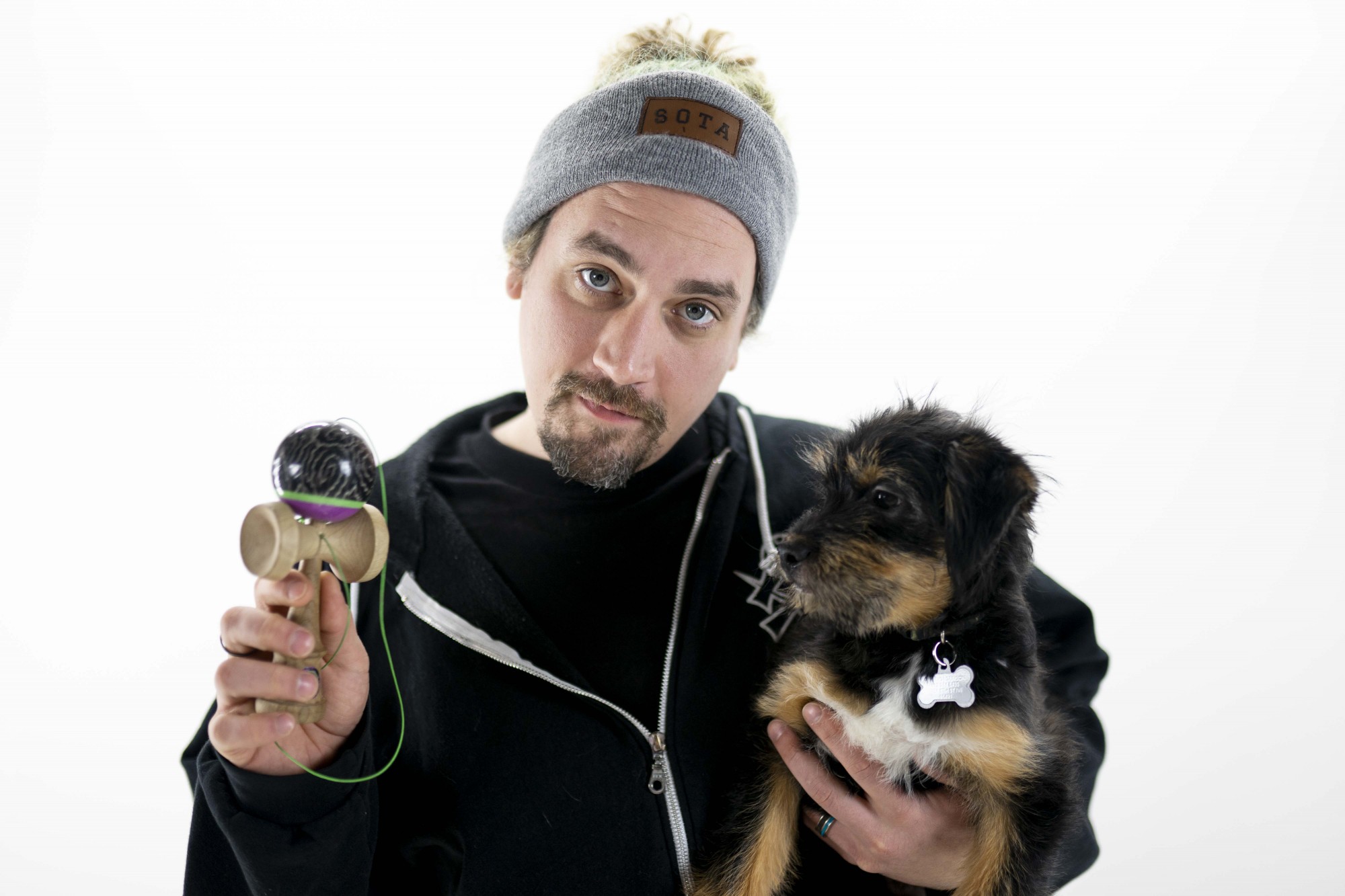 Matt Jorgenson, otherwise known as Sweets, poses for a portrait with his dog, Taz, on Monday, Dec. 2. Jorgenson, a University of Minnesota alumni, cofounded Sweets Kendamas in 2010 as a way to grow the Kendama community. 