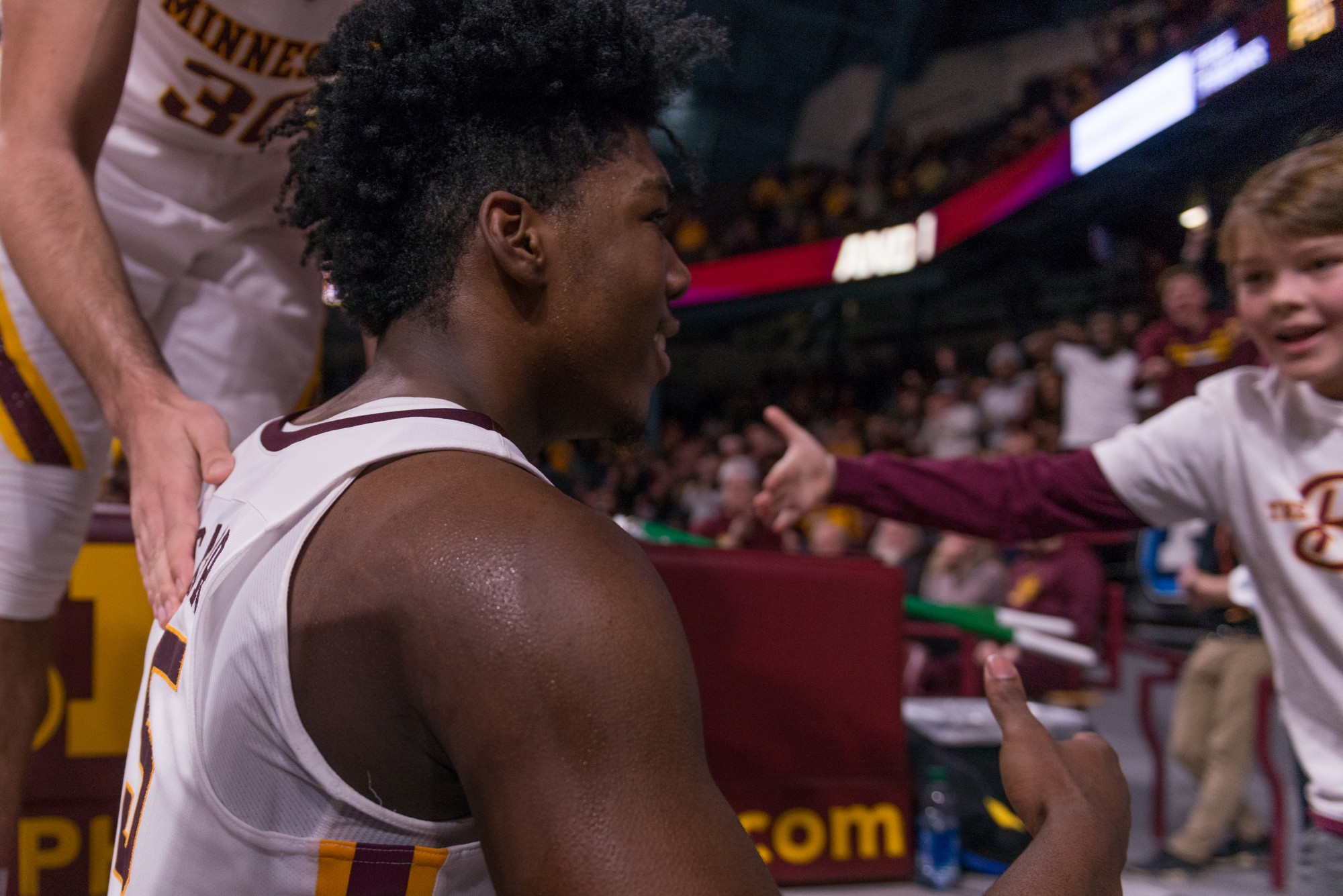 Gophers Guard Marcus Carr shakes the hand of a young fan at Williams Arena on Wednesday, Jan. 15.  Minnesota defeated the Penn State Nittany Lions 75-69. (Kamaan Richards / Minnesota Daily)
