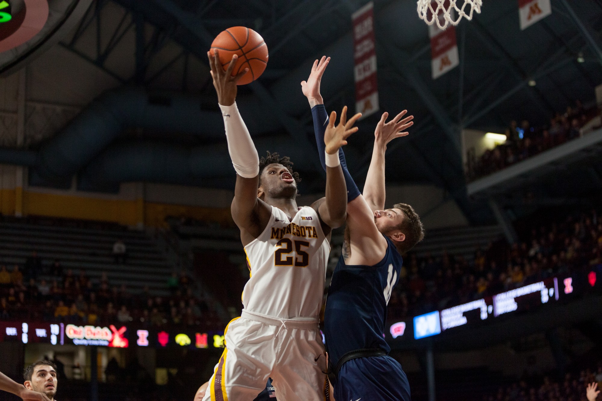 Gophers Center Daniel Oturu pushes past a defender for a layup at Williams Arena on Wednesday, Jan. 15.  Minnesota defeated the Penn State Nittany Lions 75-69. (Kamaan Richards / Minnesota Daily)