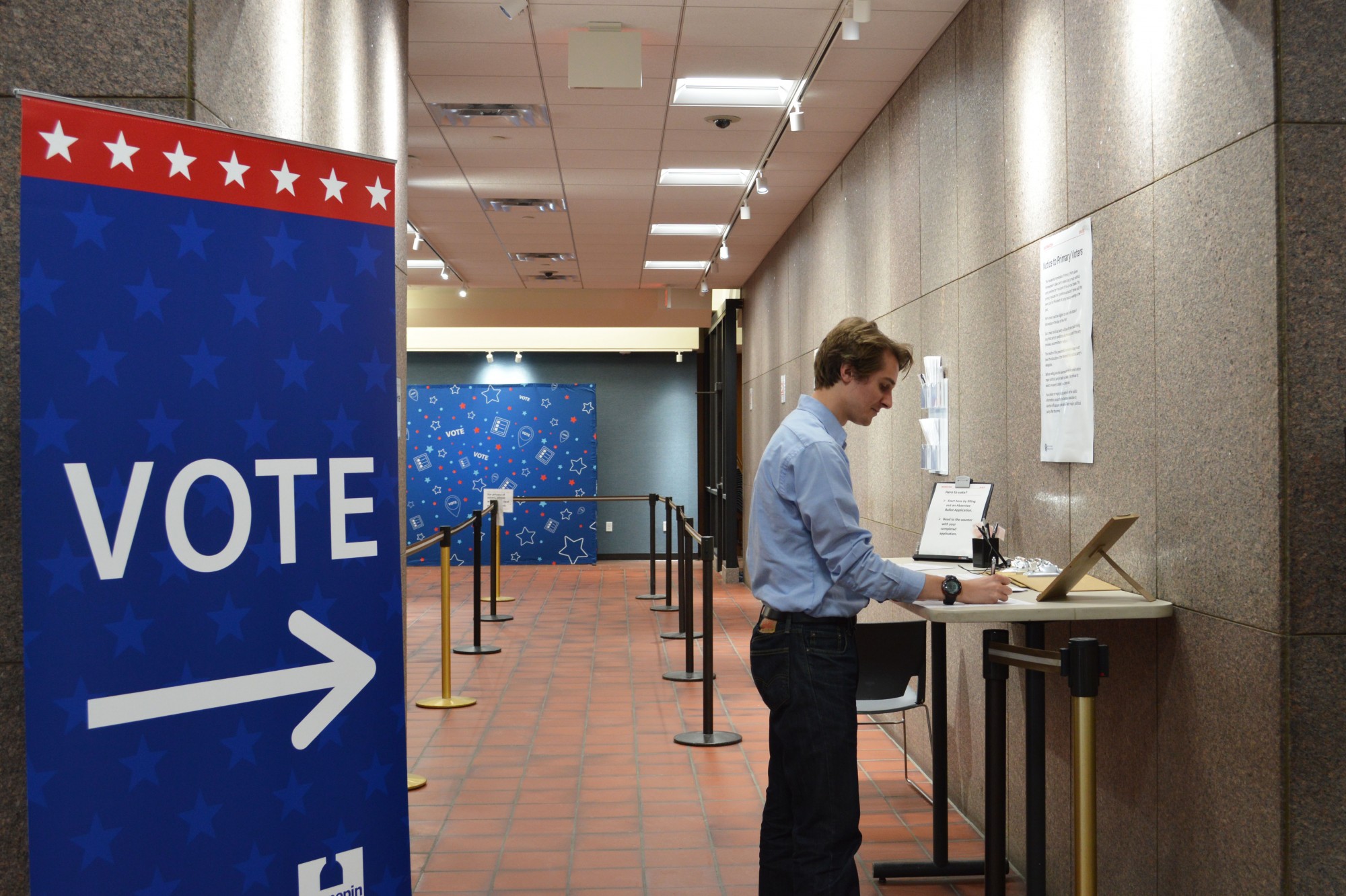Senior Sammy Lett reviews an early voting ballot at the Hennepin County Government Center on Wednesday, Jan. 22. 