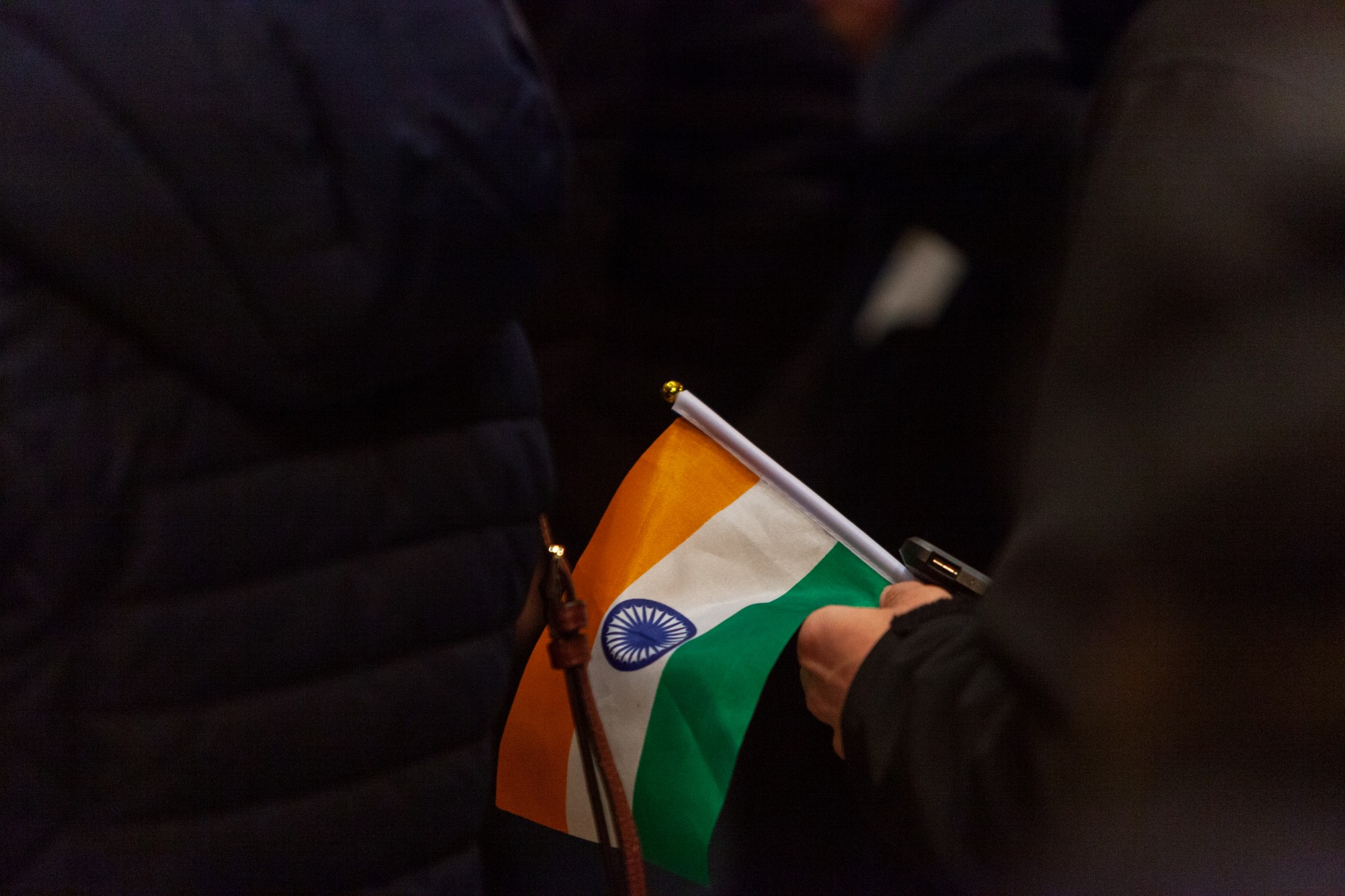 An attendee clutches a miniature Indian flag at an event opposing Indias recent passage of the Citizenship Amendment Act at the Minnesota State Capitol Building on Sunday, Jan. 26. This legislation offers Indian citizenship to refugees of several religious groups, but does not apply to Muslims, despite their making up nearly 15% of the Indian population.