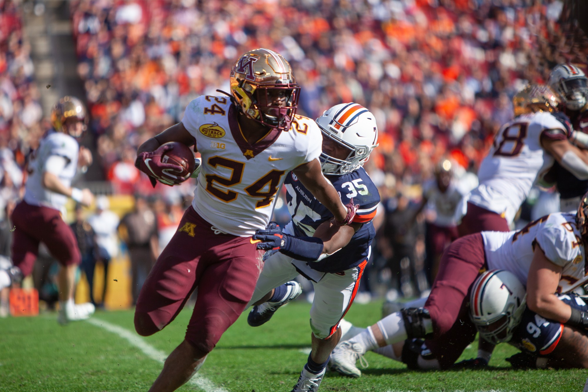Gophers Runningback Mohamed Ibrahim carries the ball at Raymond James Stadium in Tampa, Florida on Wednesday, Jan. 1. Minnesota holds a 24-17 lead over Auburn heading into the third quarter of the Outback Bowl. (Kamaan Richards / Minnesota Daily)
