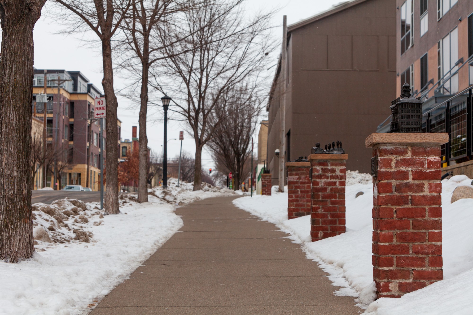 Miniature  bronze replicas of local landmarks line the sidewalk at the Neighborhood Gateway in the Marcy Holmes neighborhood on Tuesday, Jan. 28.  The neighborhood provides housing for a significant number of University students.