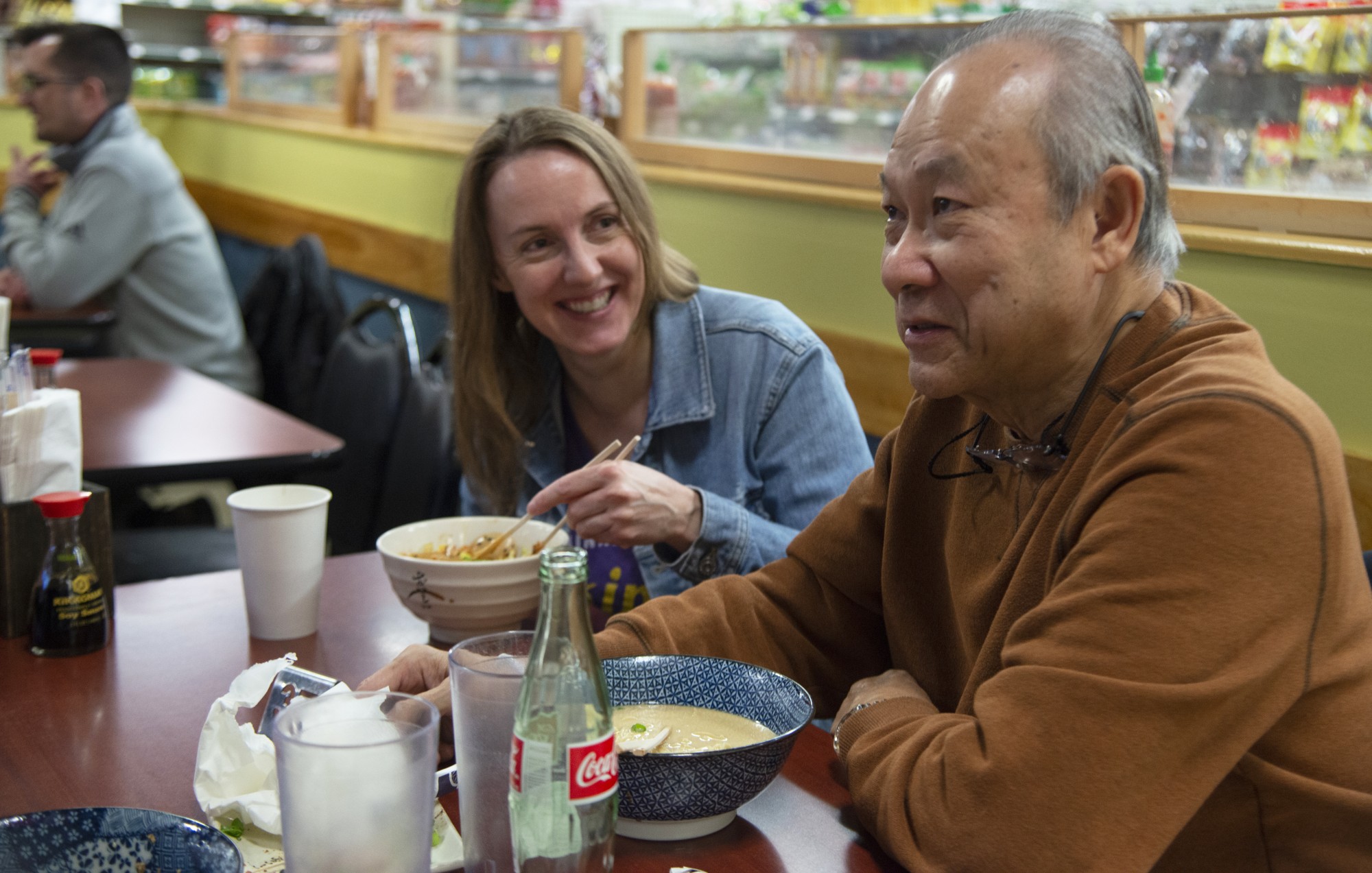 United Noodles co-owner Annie Dingle, left, and the markets founder and former owner, Ramon Tan, right, eat ramen from the Unideli ramen shop located inside of United Noodles on Thursday, Jan. 30. 