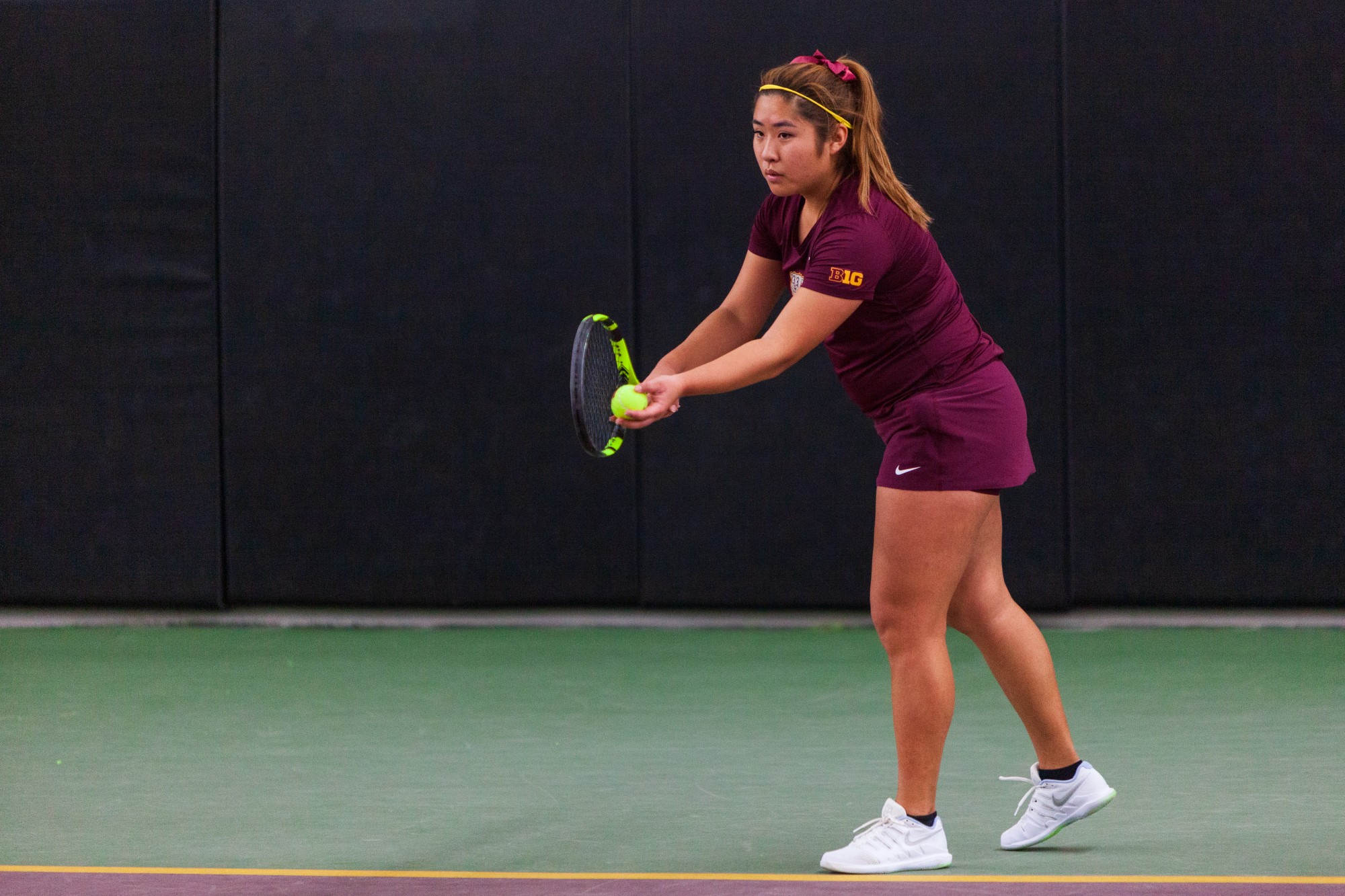 Gophers Junior Juliet Zhang prepares to serve at the Baseline Tennis Center on Friday, Feb. 7.