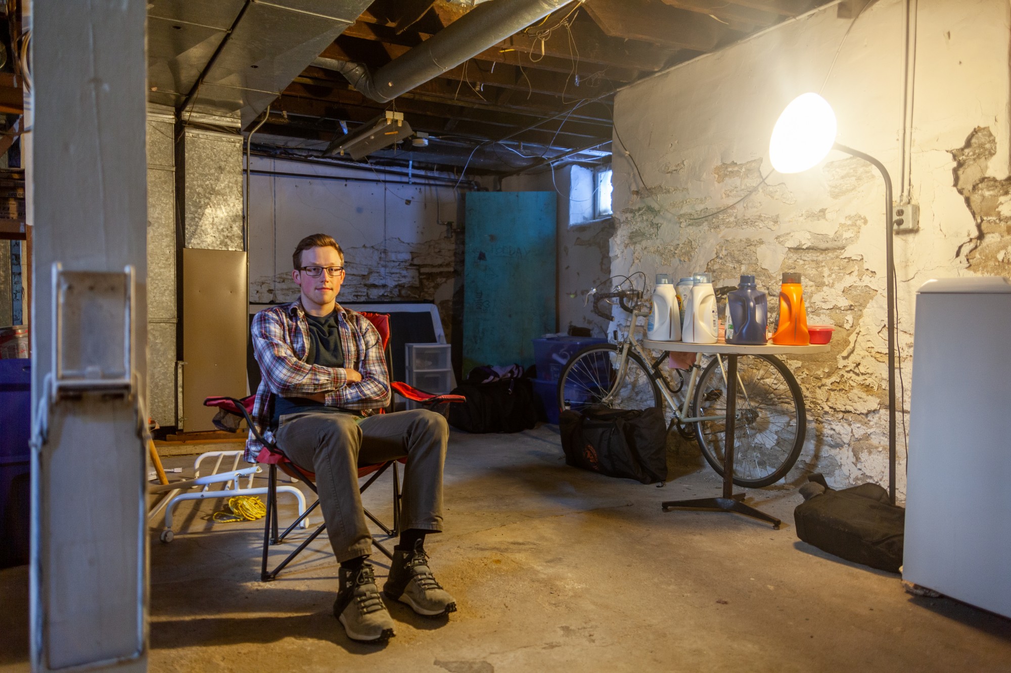 Senior Garrett Williams poses for a portrait in the basement of his former residence in the Como Neighborhood on Saturday, Feb. 8.  The Miles Realty property, where Williams lived for his junior year, suffered from a lack of maintenance, with issues sometimes taking months to resolve.